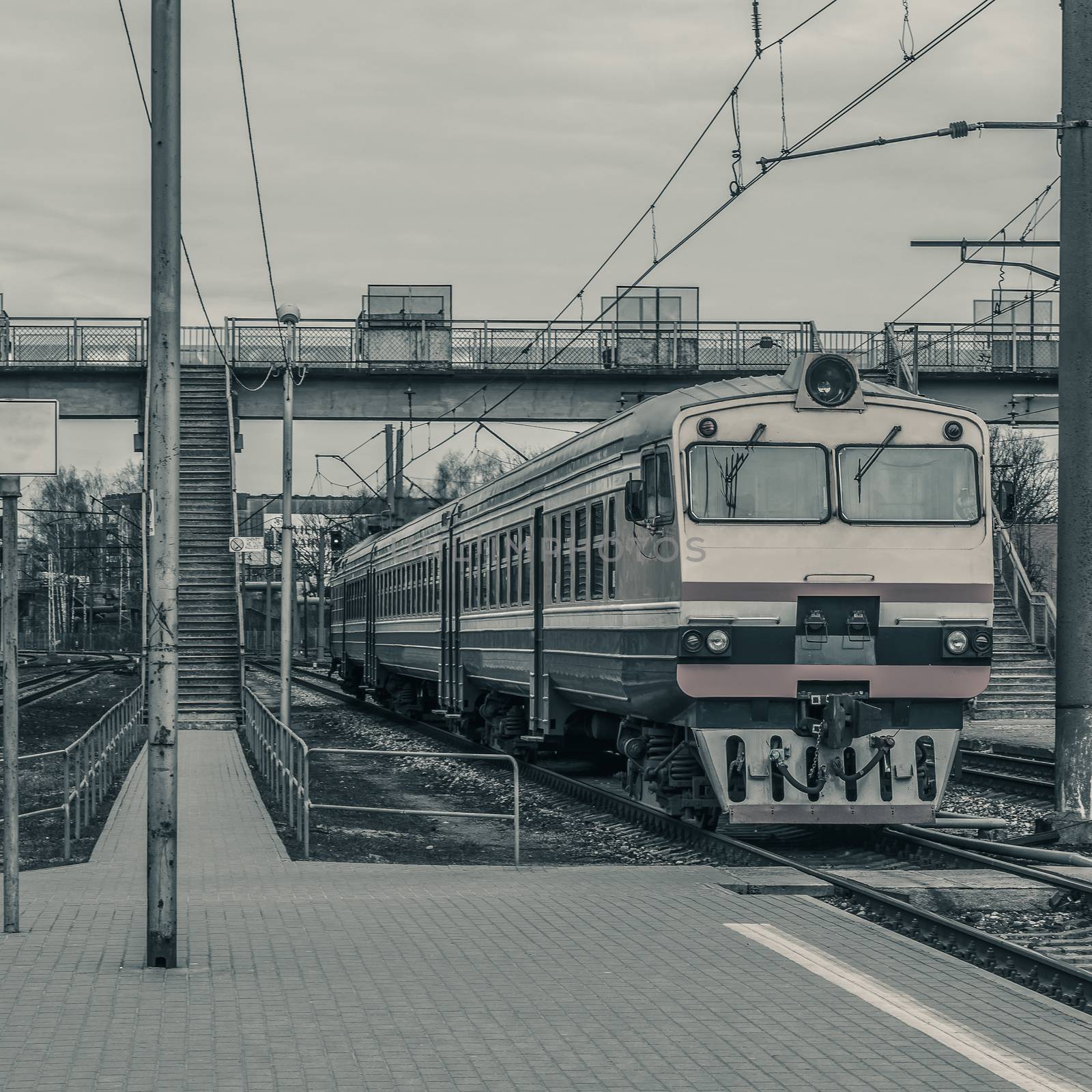 Old passenger diesel train moving at the terminal