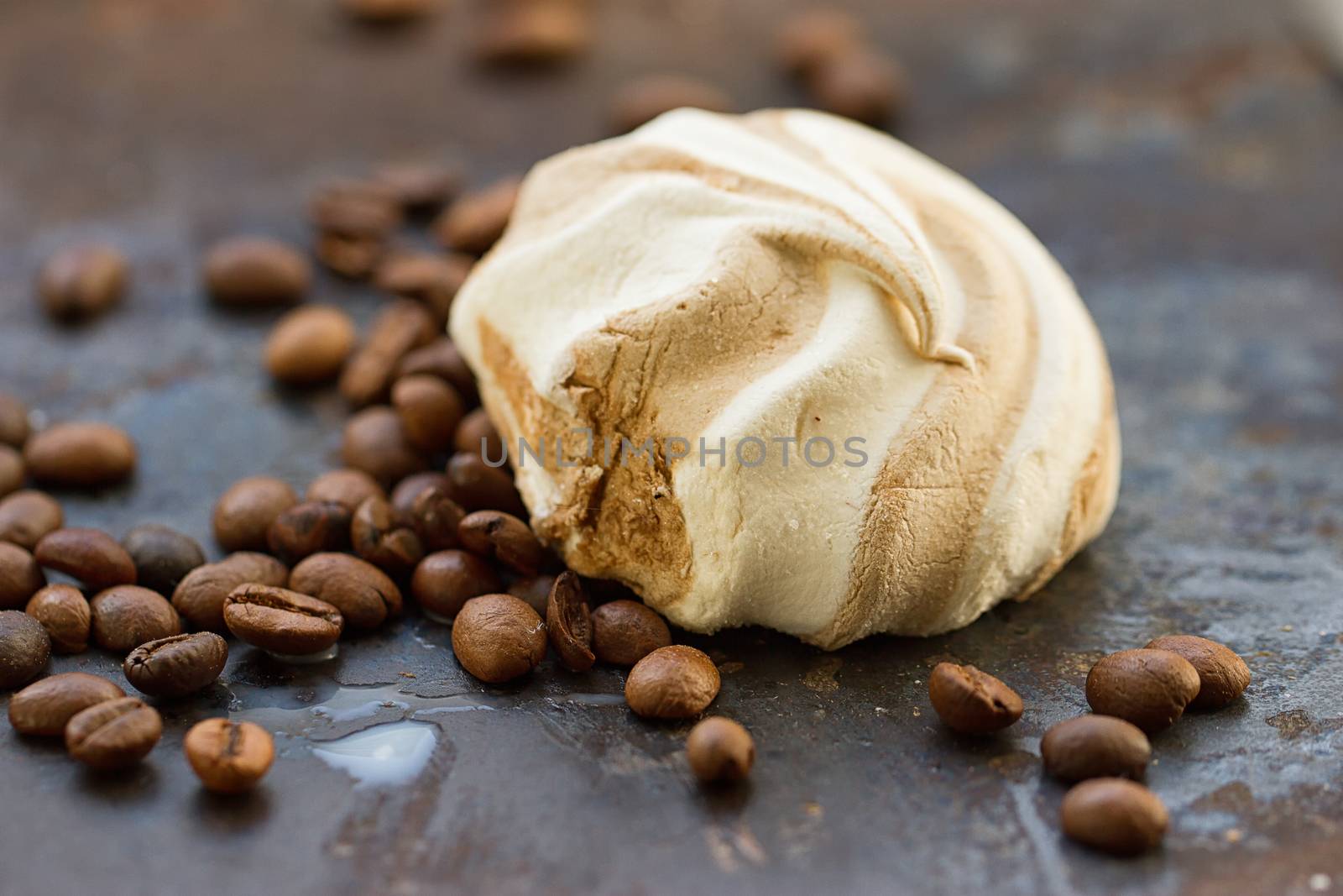 One marshmallow and coffee beans on grounge background