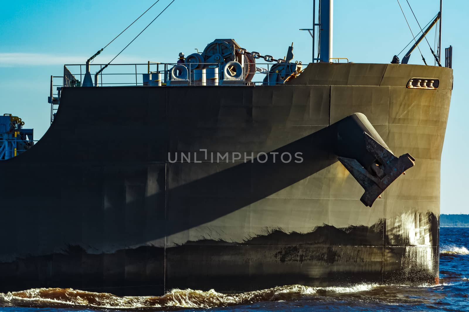 Black cargo ship moving to Baltic sea at clear day