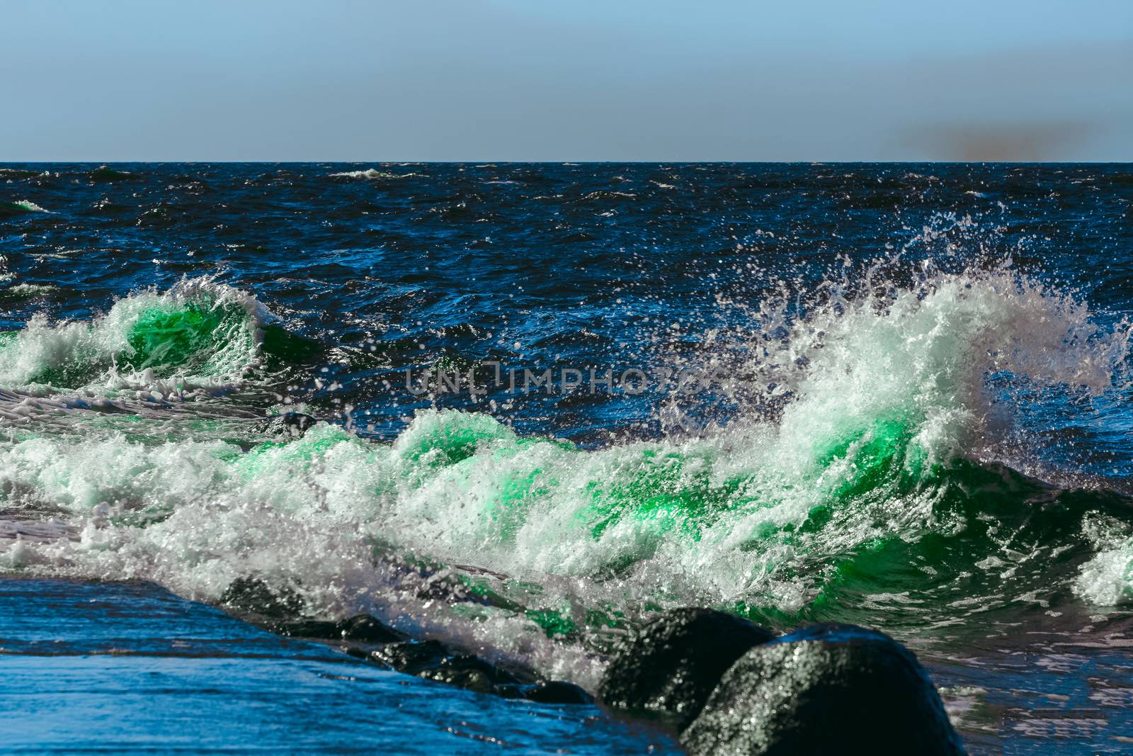 Summer ocean beach with green waves at sunny day