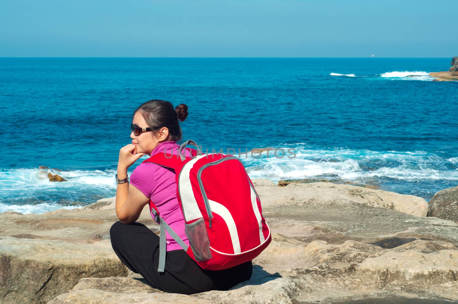 A girl explores the coastline of Bondi Beach in Sydney,Australia.