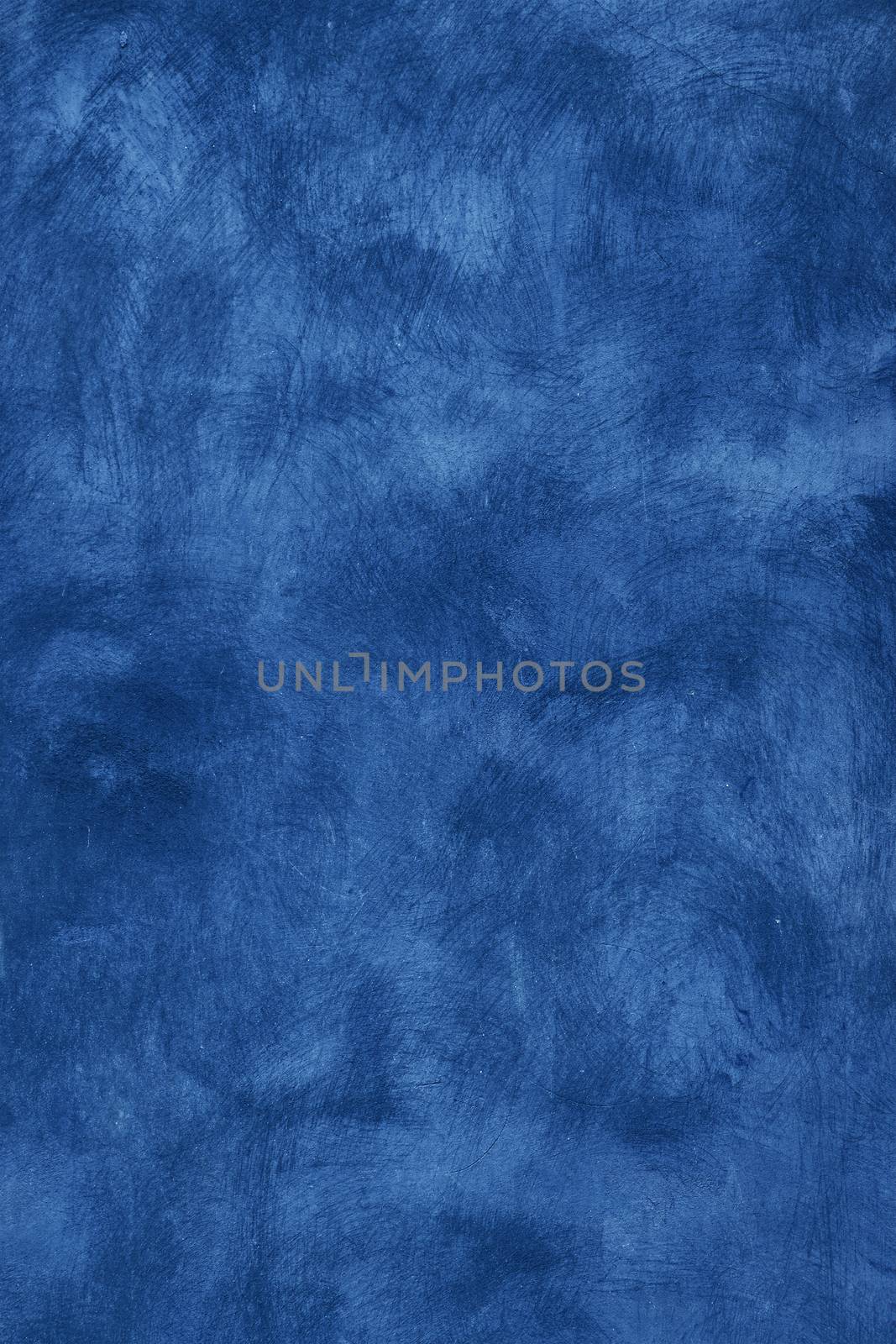 Grunge blue faded uneven old aged daub plaster wall texture background with stains and paint strokes, close up