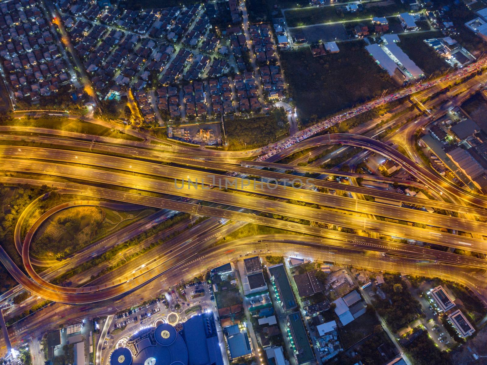 Aerial view of expressway and motorway at night shot by drone in Bangkok, Thailand.