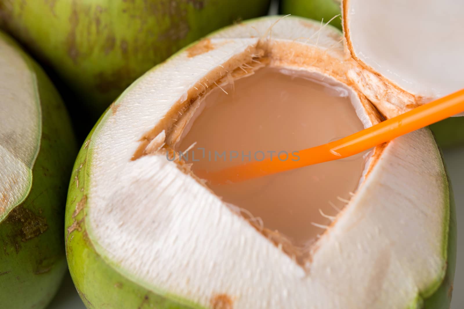 open fresh coconut with straw by antpkr