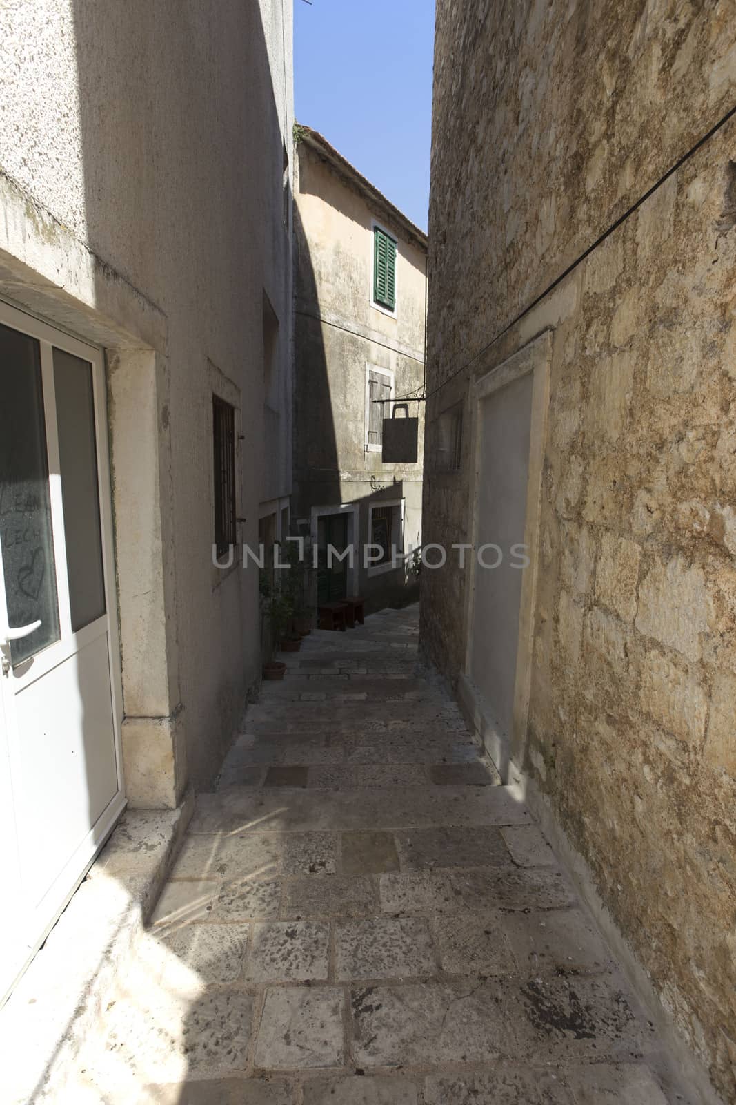 Narrow empty street of medieval town by eswaran