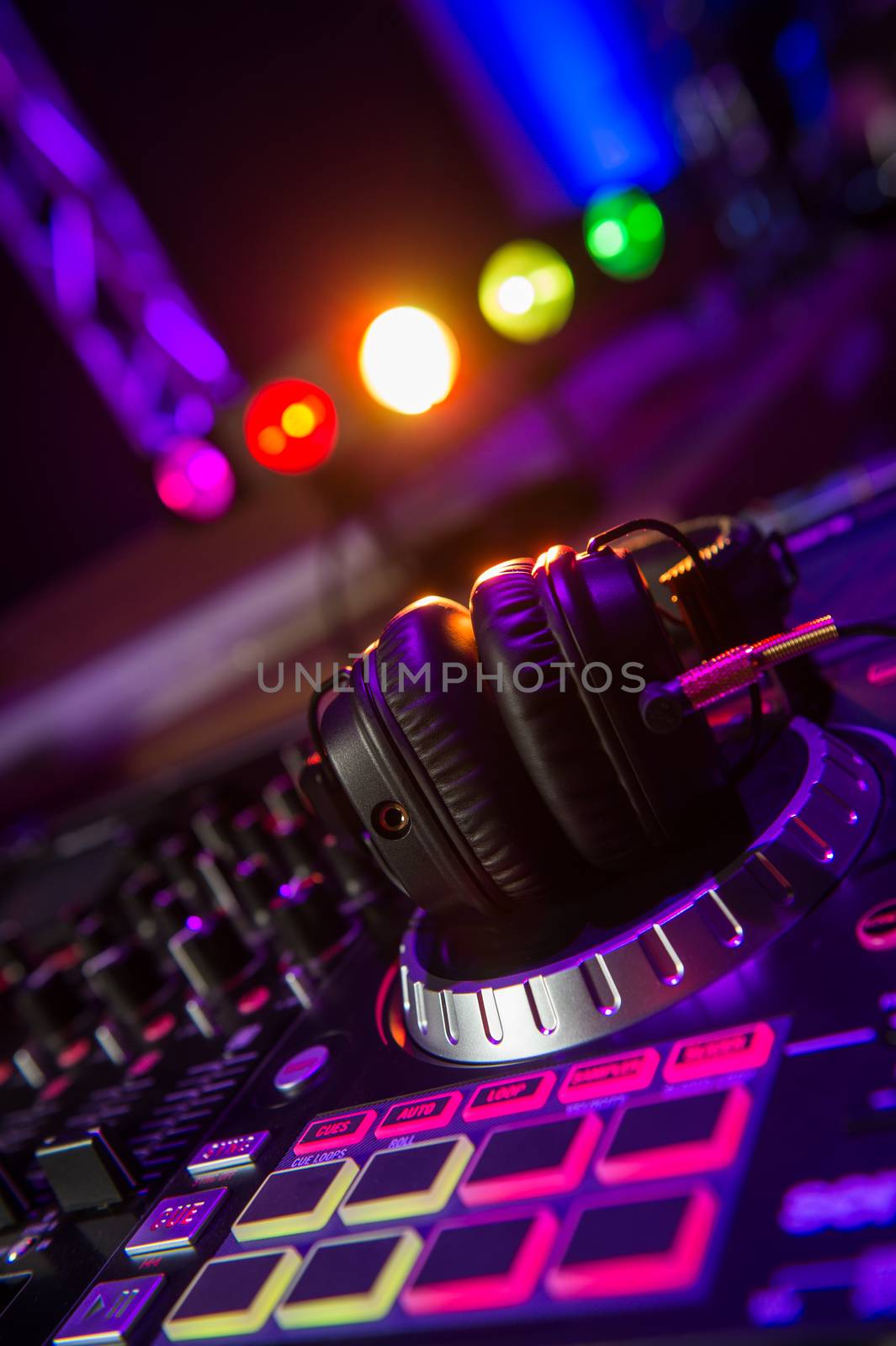 Dj mixer with headphones at a nightclub, music