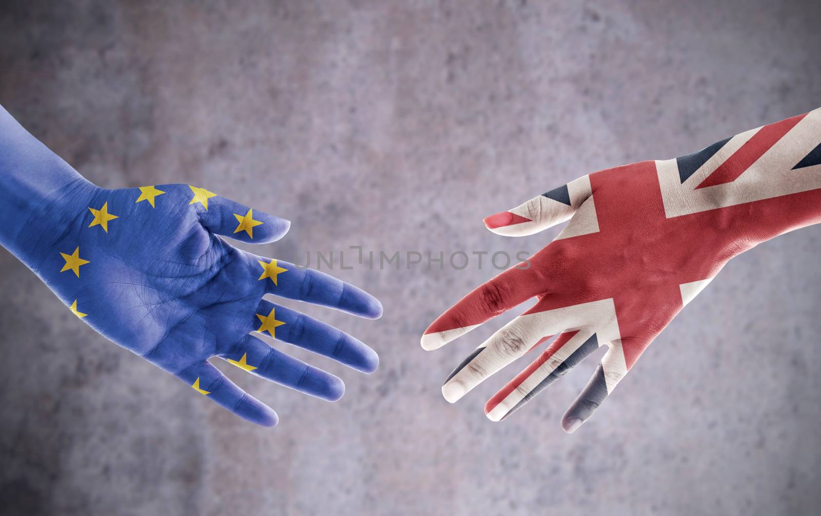 Hands painted with UK and European flag reaching out for a handshake