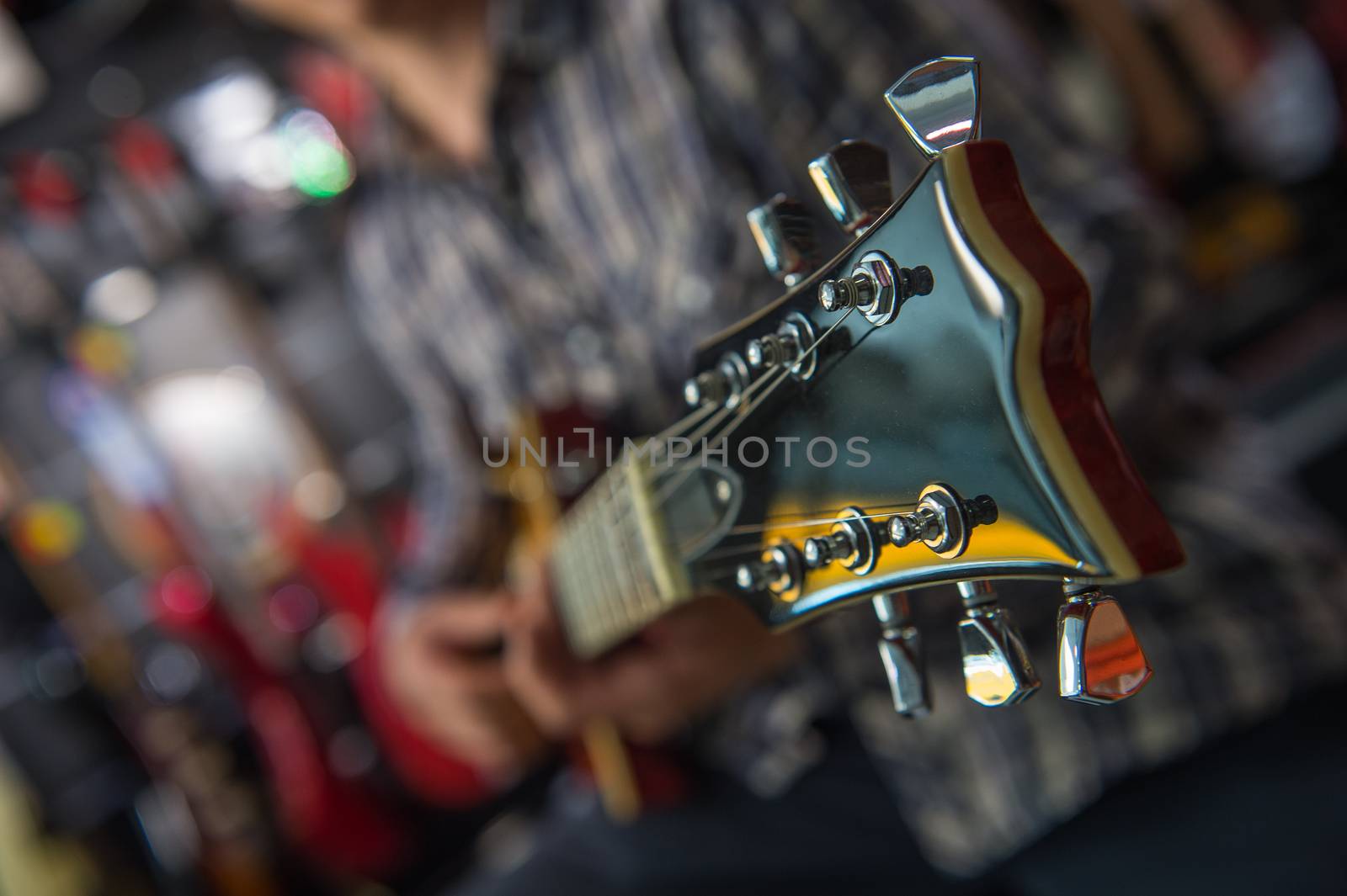 Young man playing the guitar in a shop, France