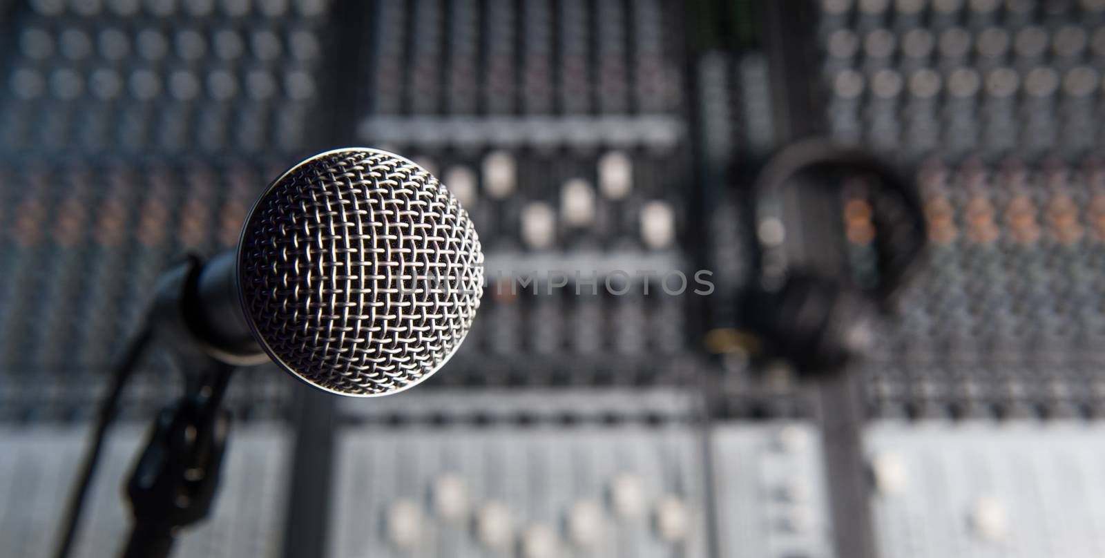 Microphone and Headphones on dirty sound mixer panel, France