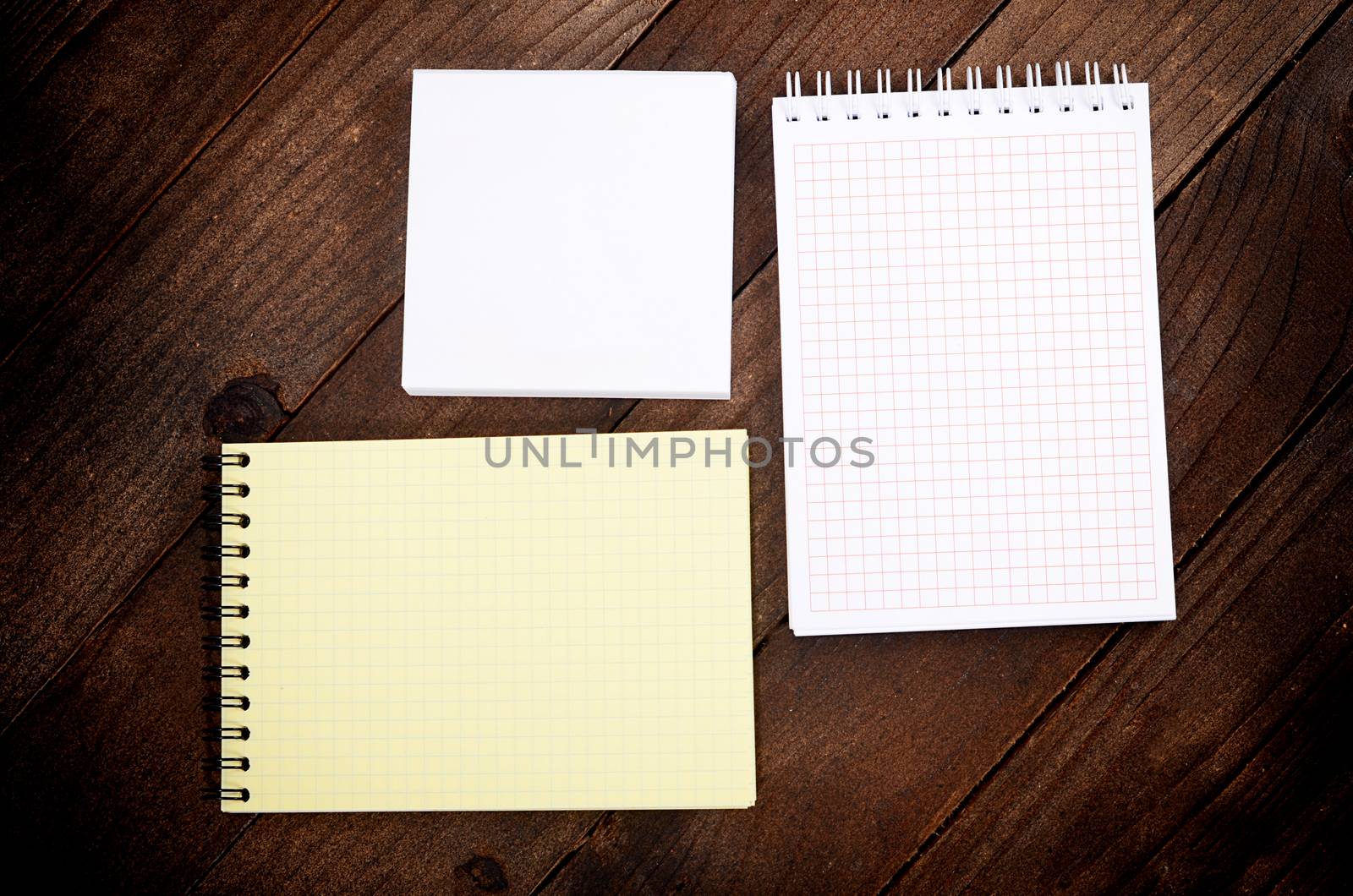 The different notebooks on a wooden table