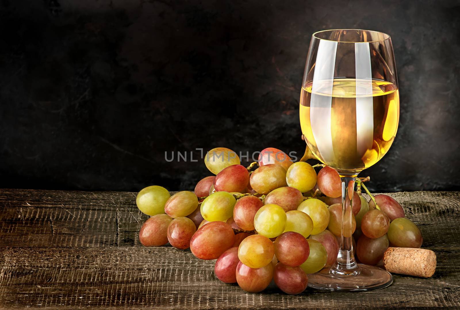 Glass of white wine with grapes by Cipariss