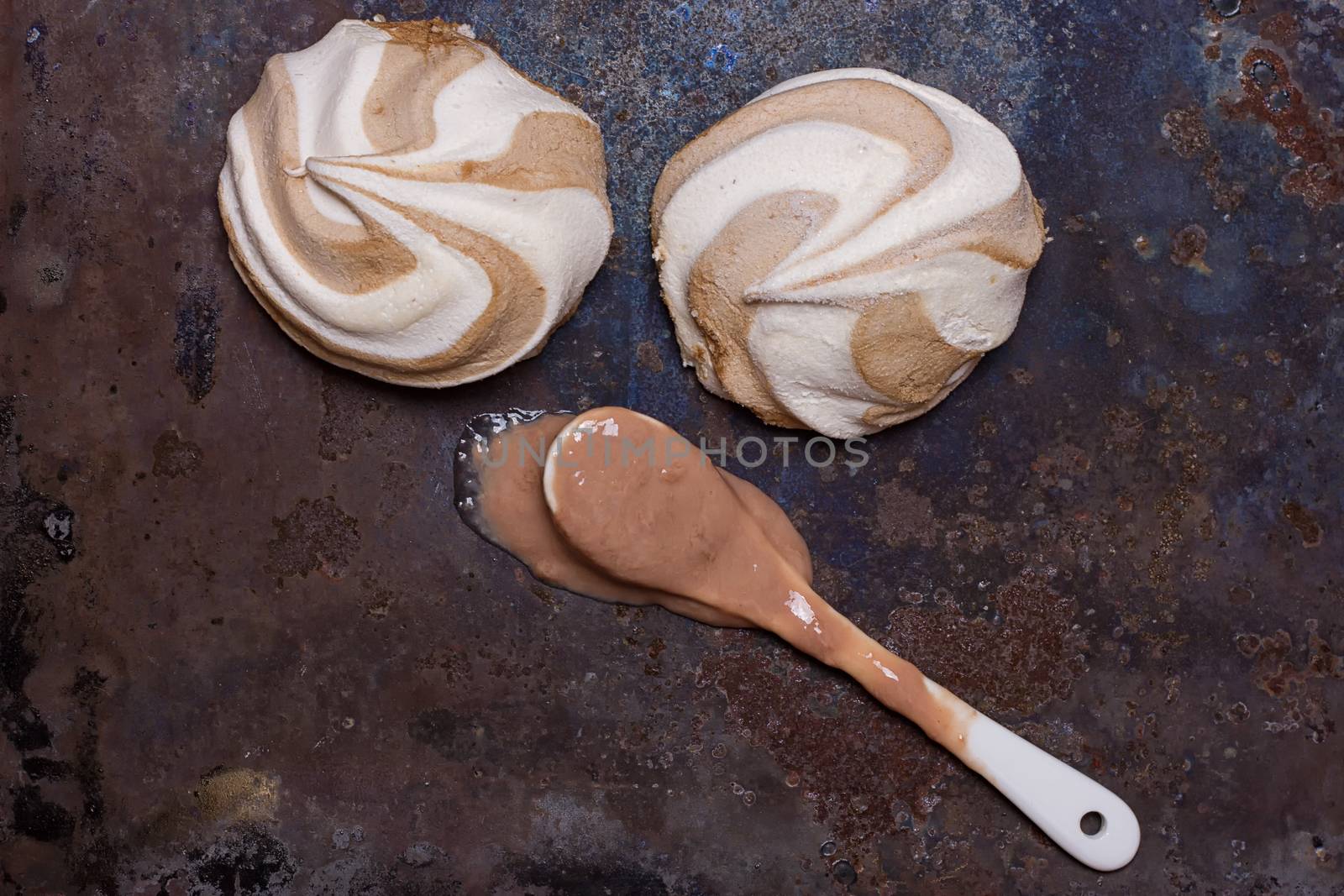 zephyr and a spoon with melted ice cream on a grunge background