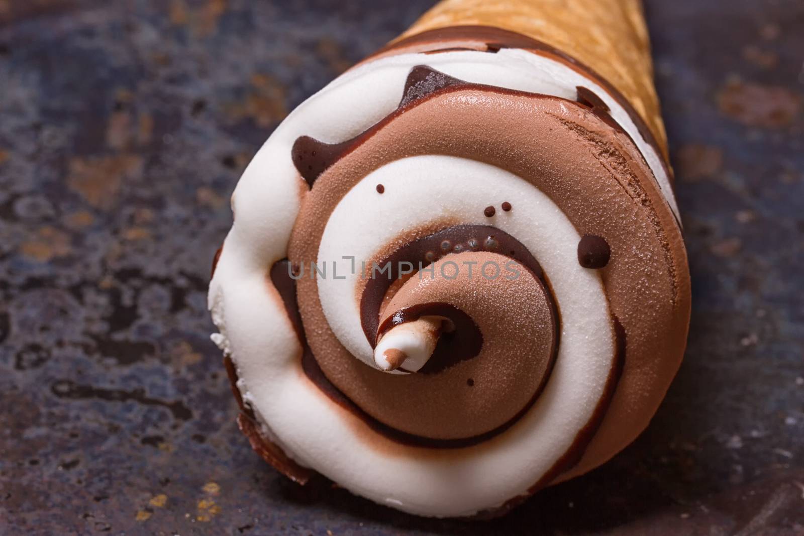 Vanilla ice cream cone with chocolate on an old grunge background