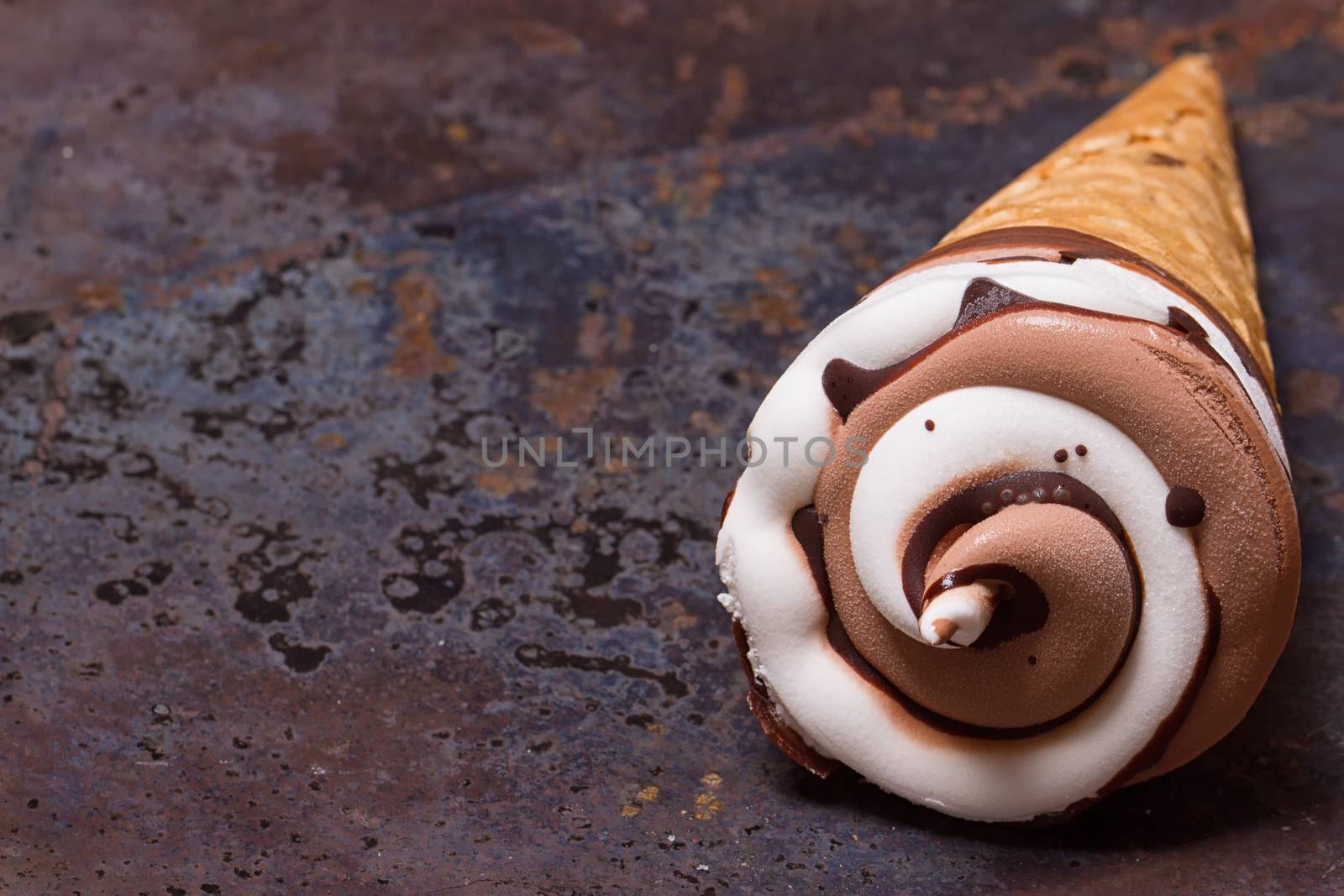 Vanilla ice cream cone with chocolate on an old grunge background