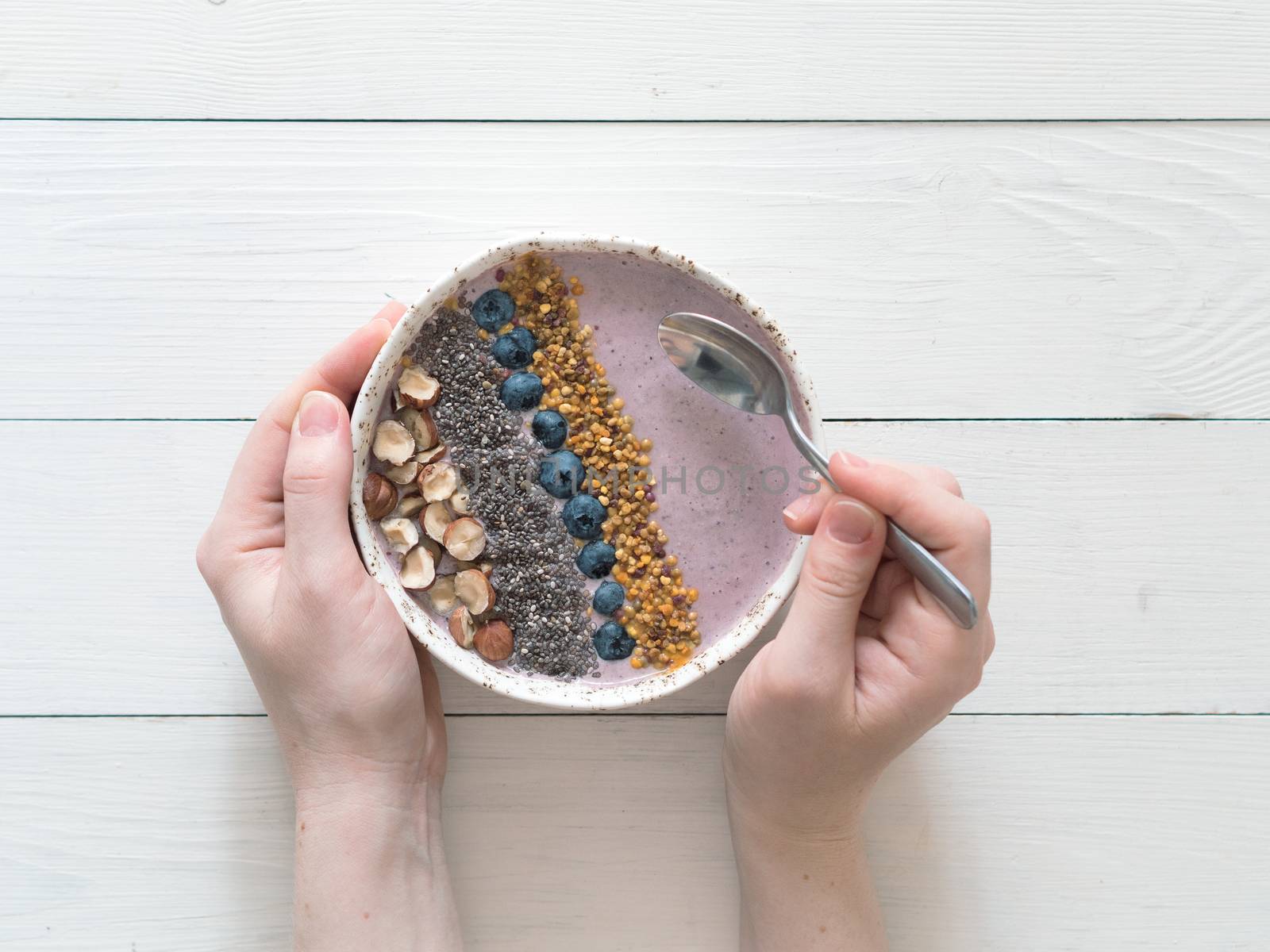 Breakfast bowl in woman hands by fascinadora
