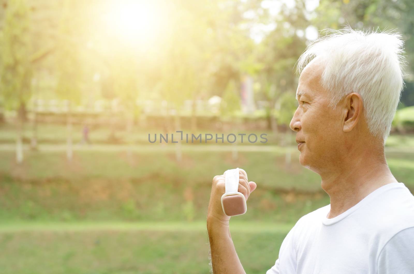 Portrait of active healthy white hair Asian old man exercising at outdoor park in morning.