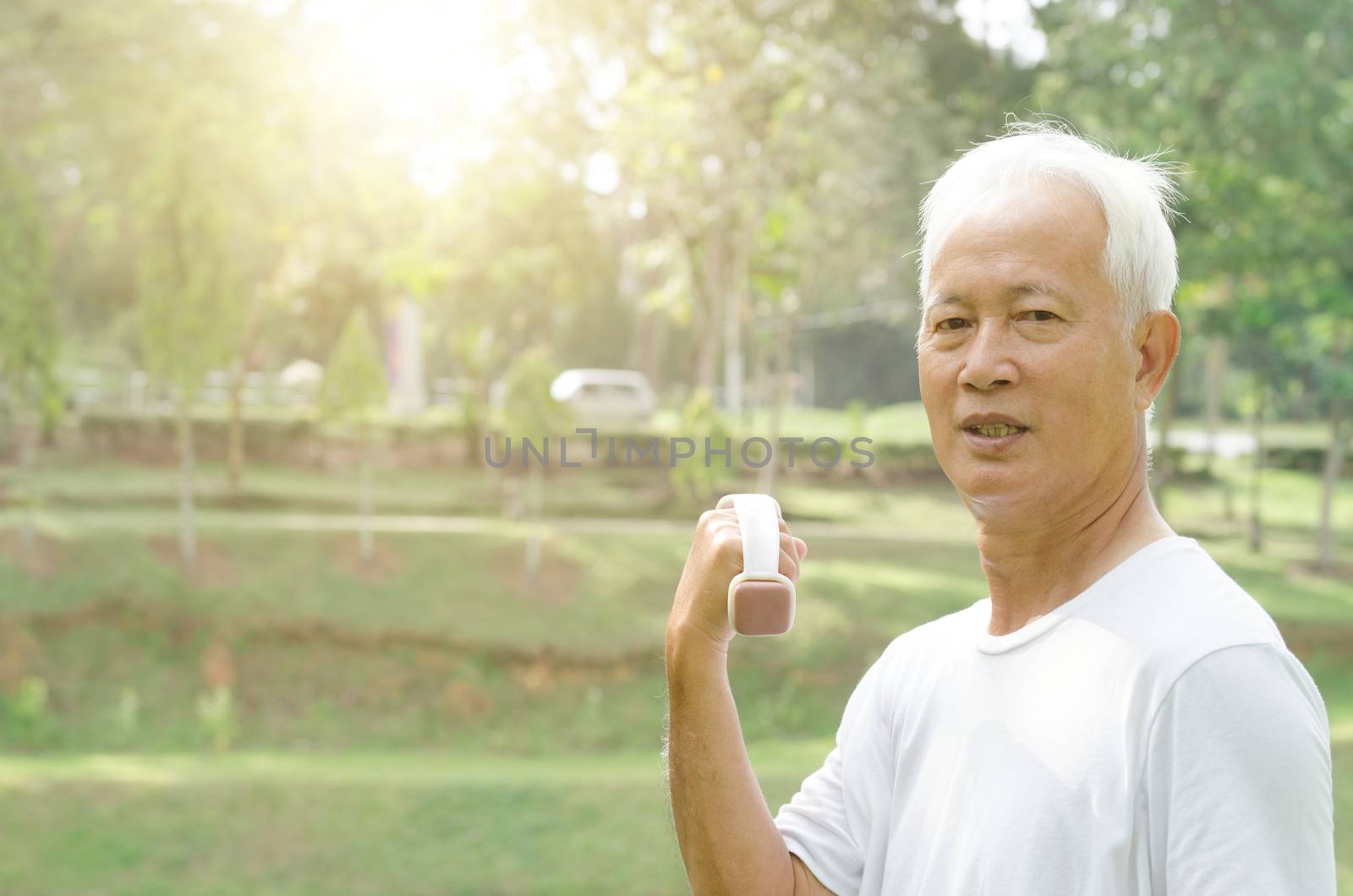 Portrait of active healthy grey hair Asian old man workout at outdoor park in morning.