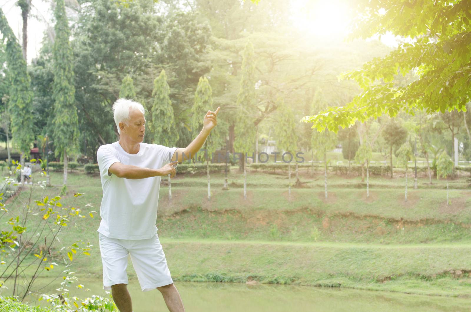 Senior people practicing tai chi outdoor  by szefei