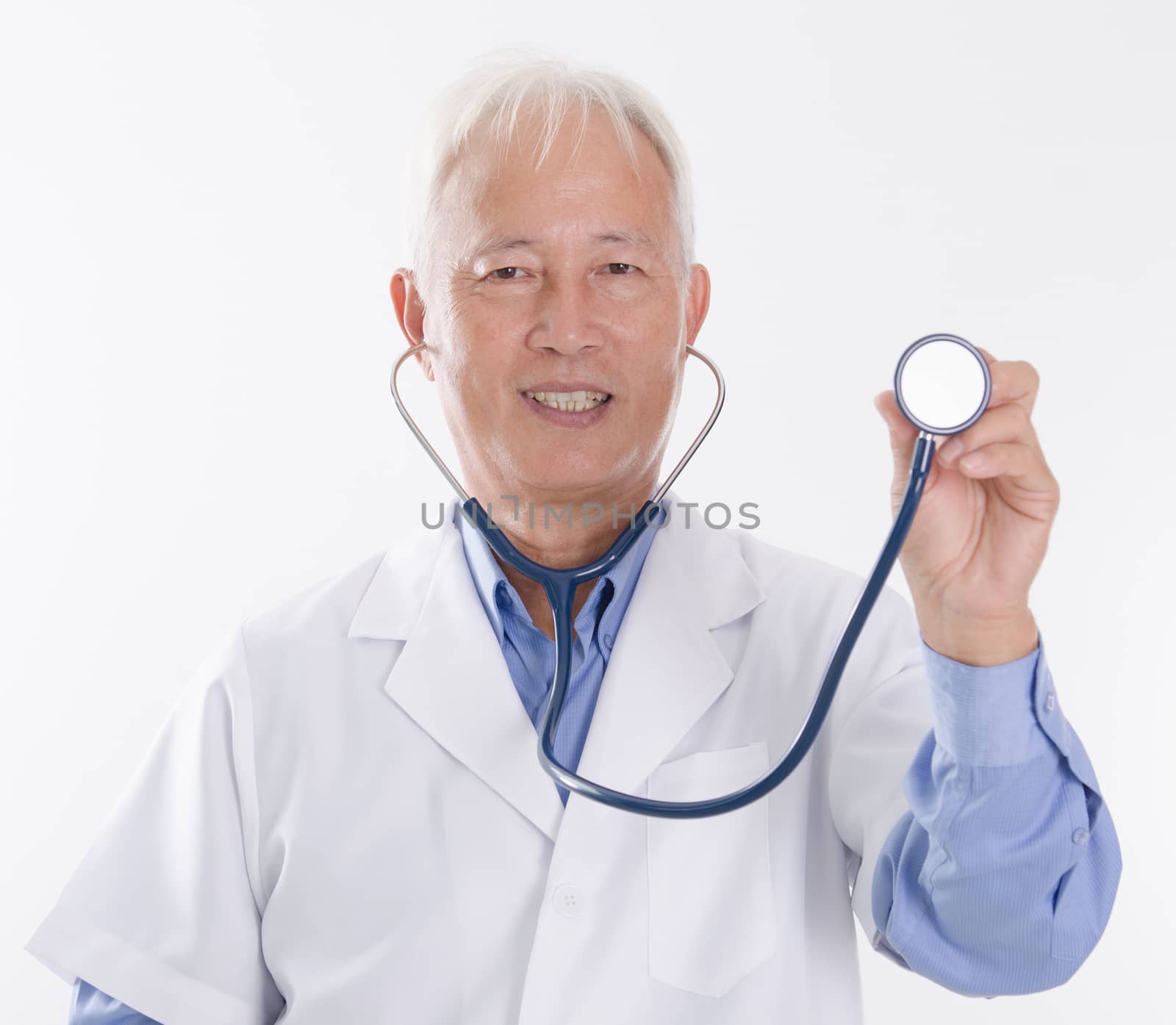 Portrait of old Asian medical doctor holding stethoscope, standing isolated on white background.