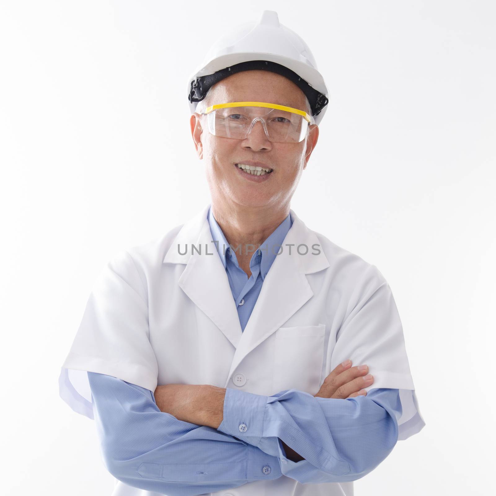 Portrait of old Asian senior engineer with hard helmet and uniform smiling, standing isolated on white background.