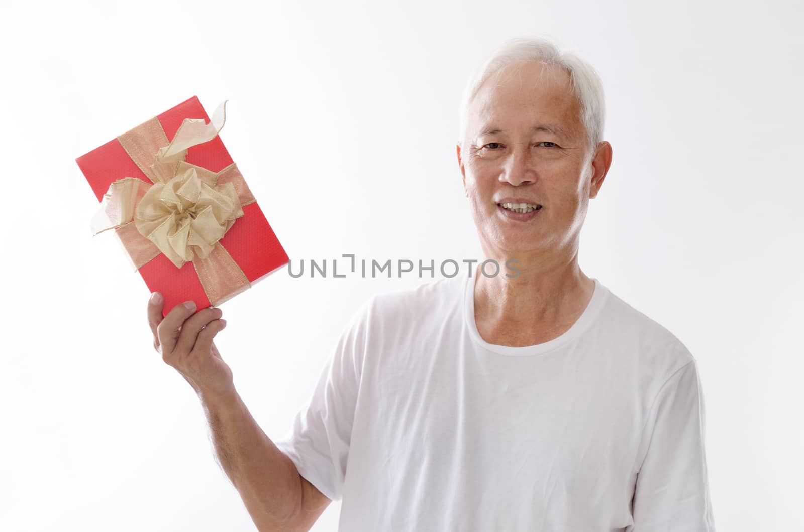 Portrait of old Asian man hand holding a gift box, isolated on white background.