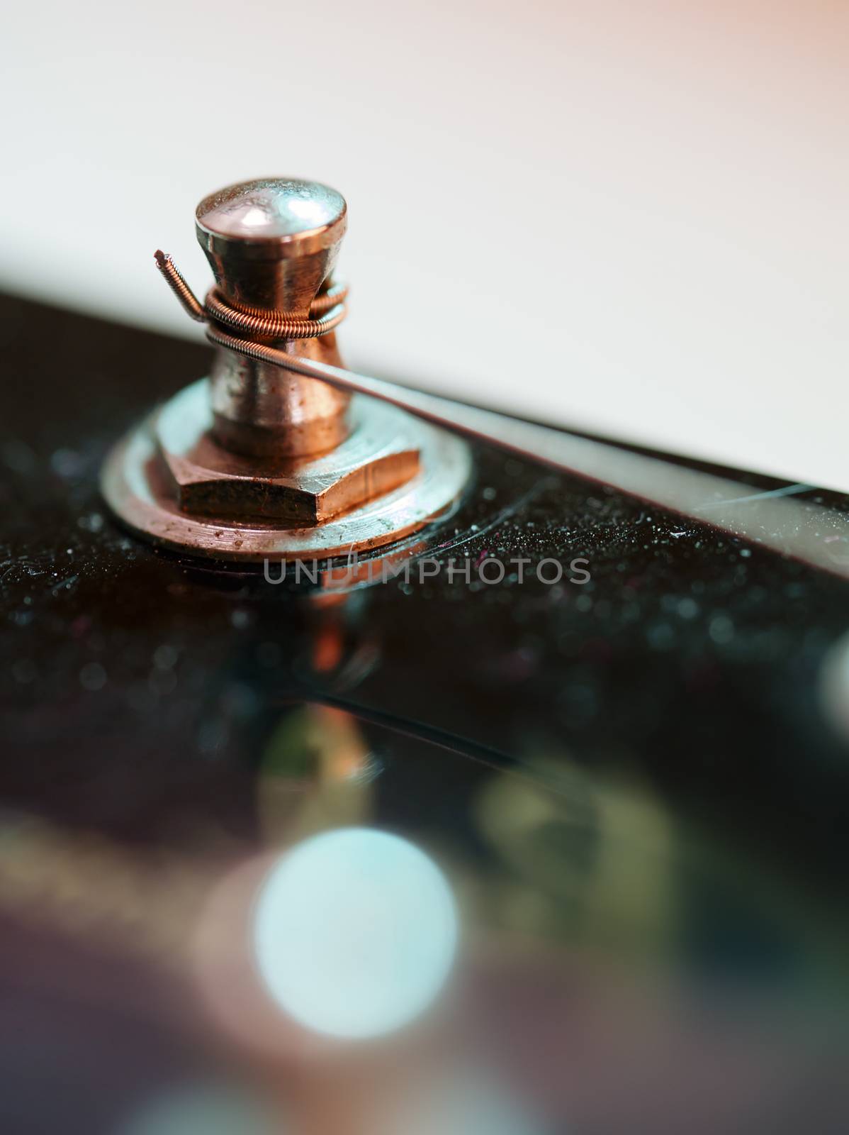 Macro abstract photo of the tuning peg and string of an electric guitar. 
