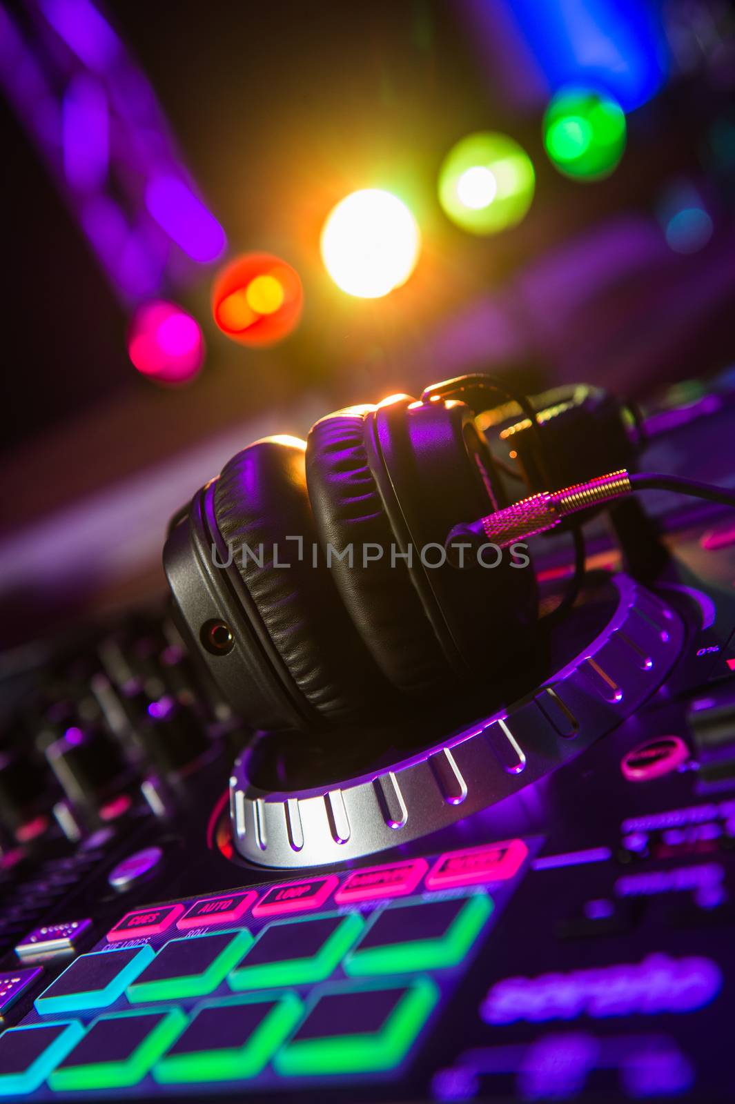 Dj mixer with headphones at a nightclub, music