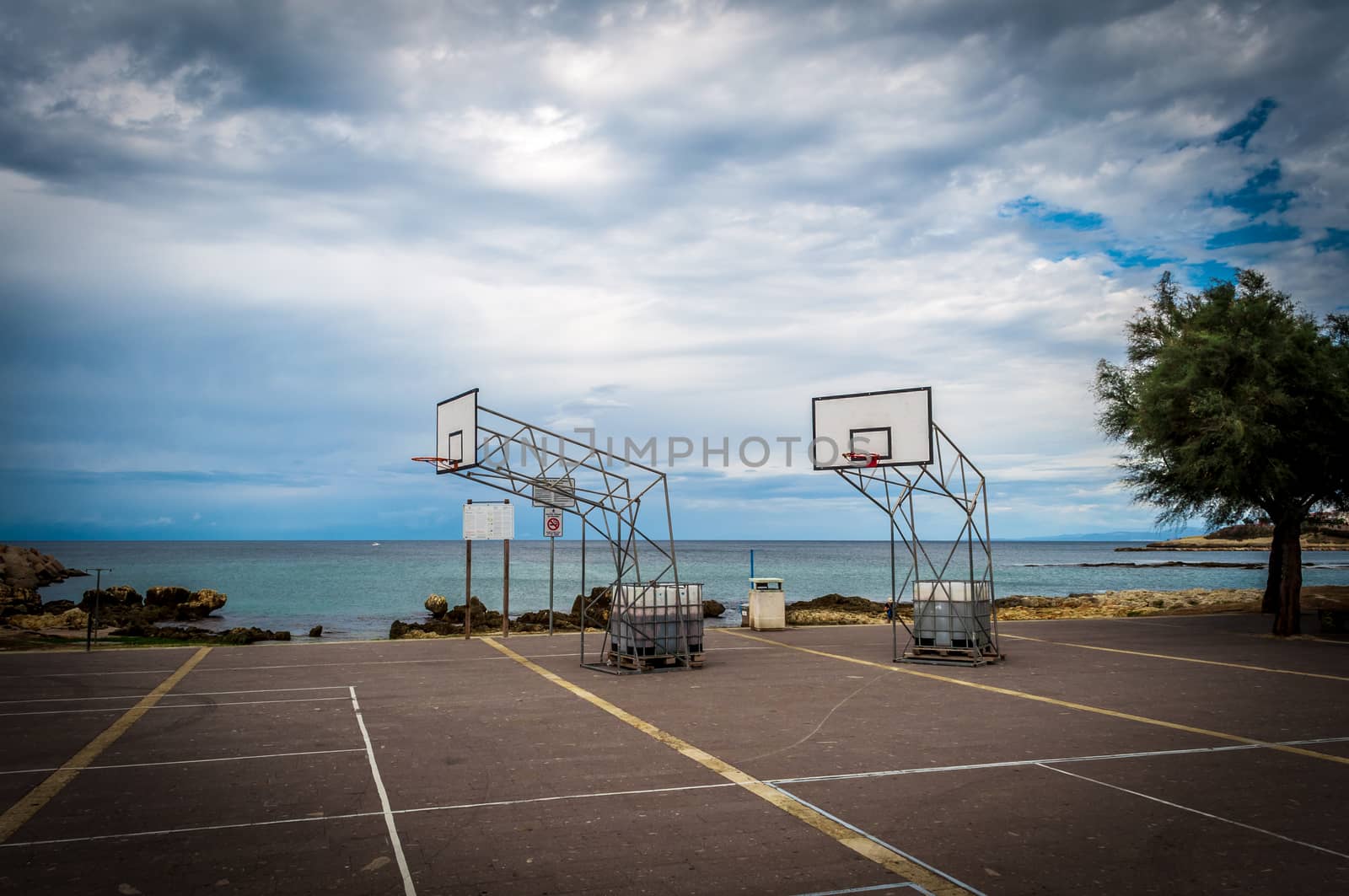 Basketball playground by the sea in a cloudy day of autumn - Porto Tores - Sardinia