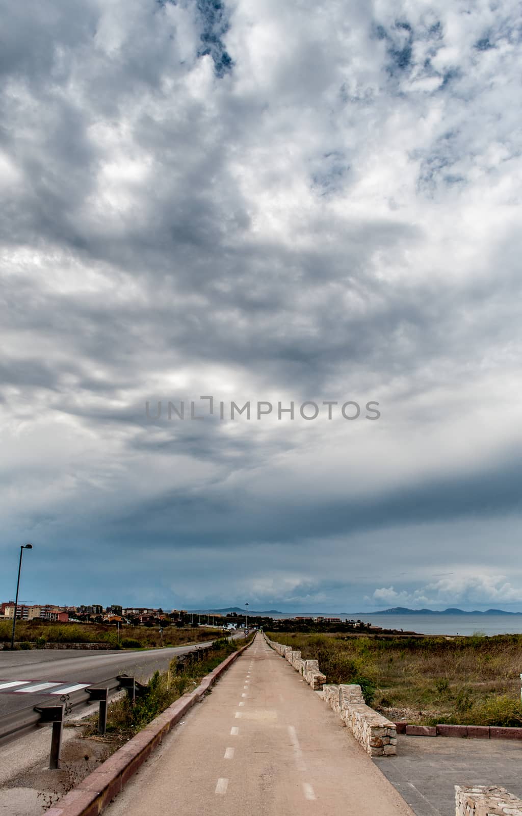 Desert street under cloudy sky in autumn - Sardinia - Asinara