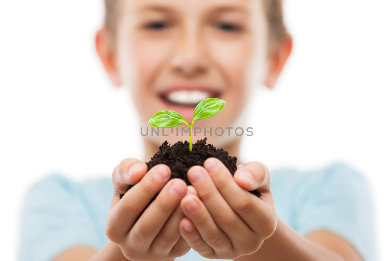 Handsome smiling child boy holding soil growing green sprout leaf by ia_64