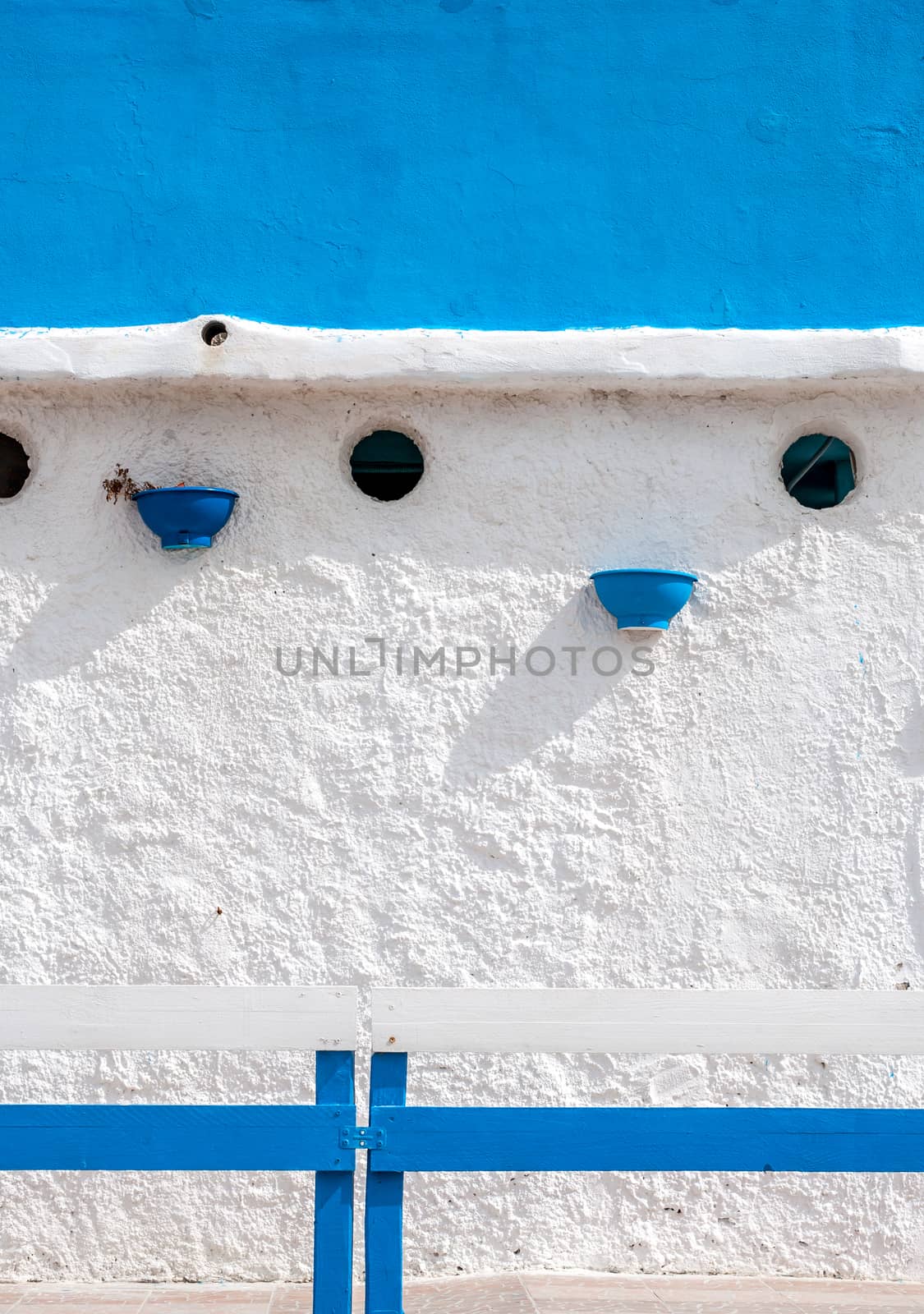 White and blue building on the beach in a cloudy day of autumn - Platamona - Sardinia - Italy