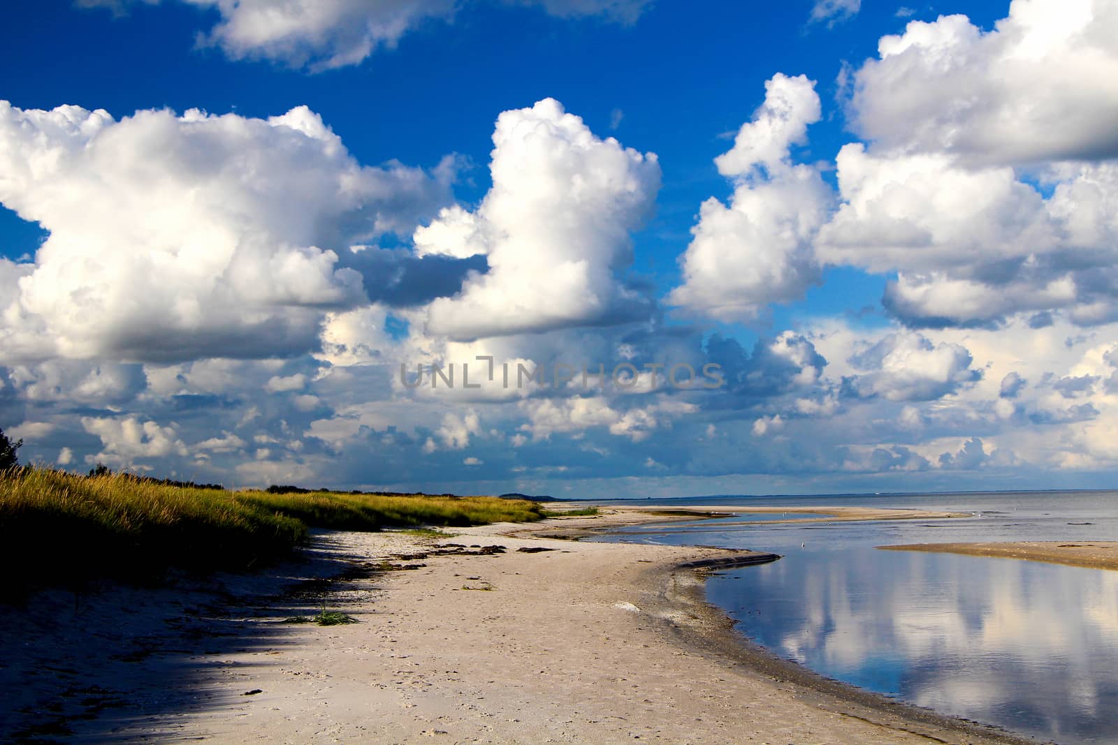 Blue sky with clouds and beach on a sunny say in summer.