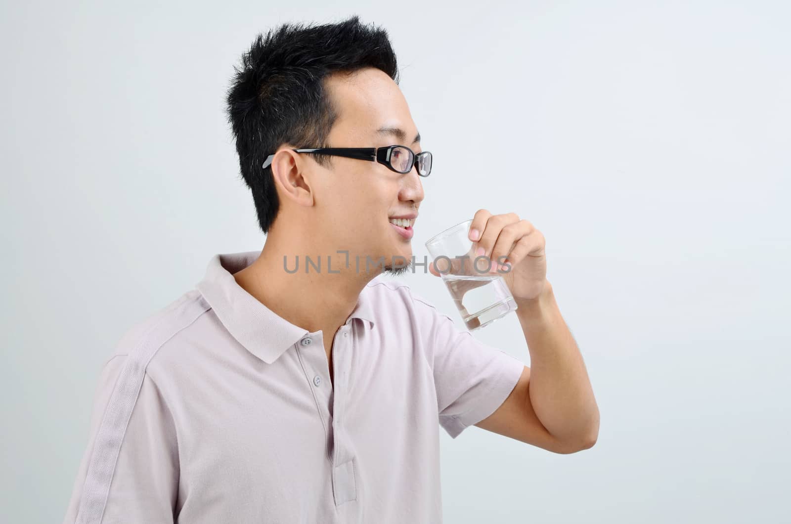 Asian male drinking mineral water by szefei