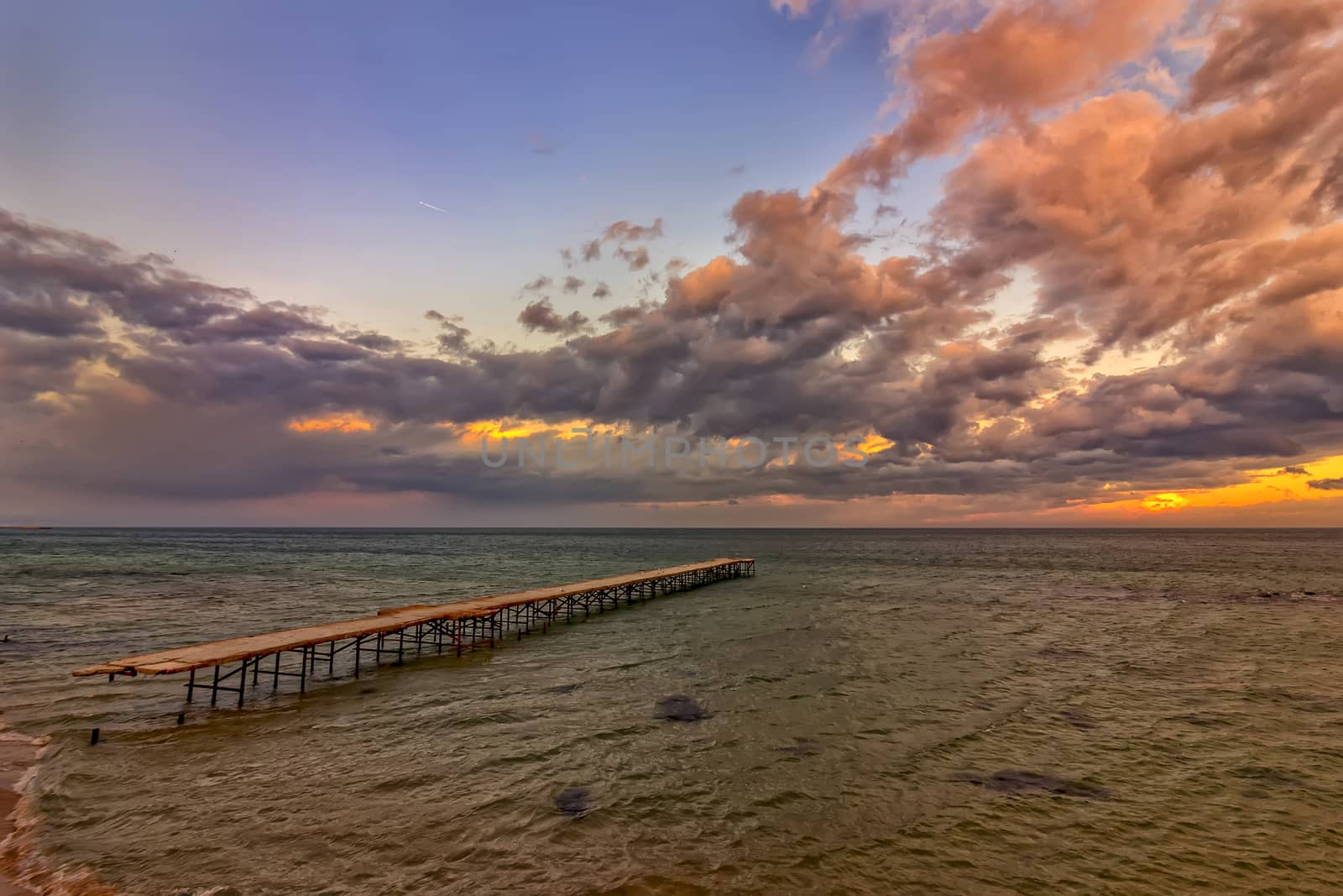 Old broken bridge in the sea , sunrise shot