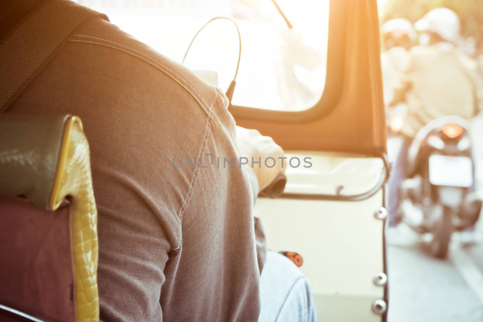 Behind of tuktuk driver in bangkok,The Motorized Tricycle are a popular way to transport in bangkok Thailand.