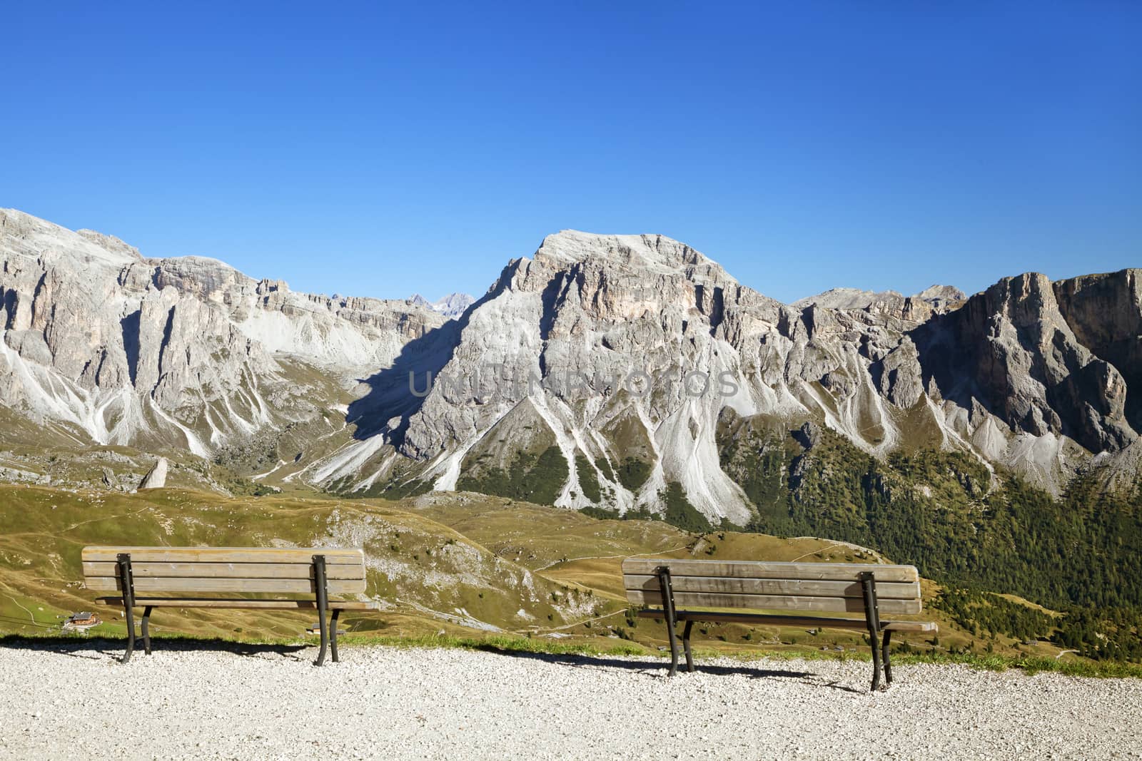 Mountain view of Dolomite Alps with empty benches in the foreground