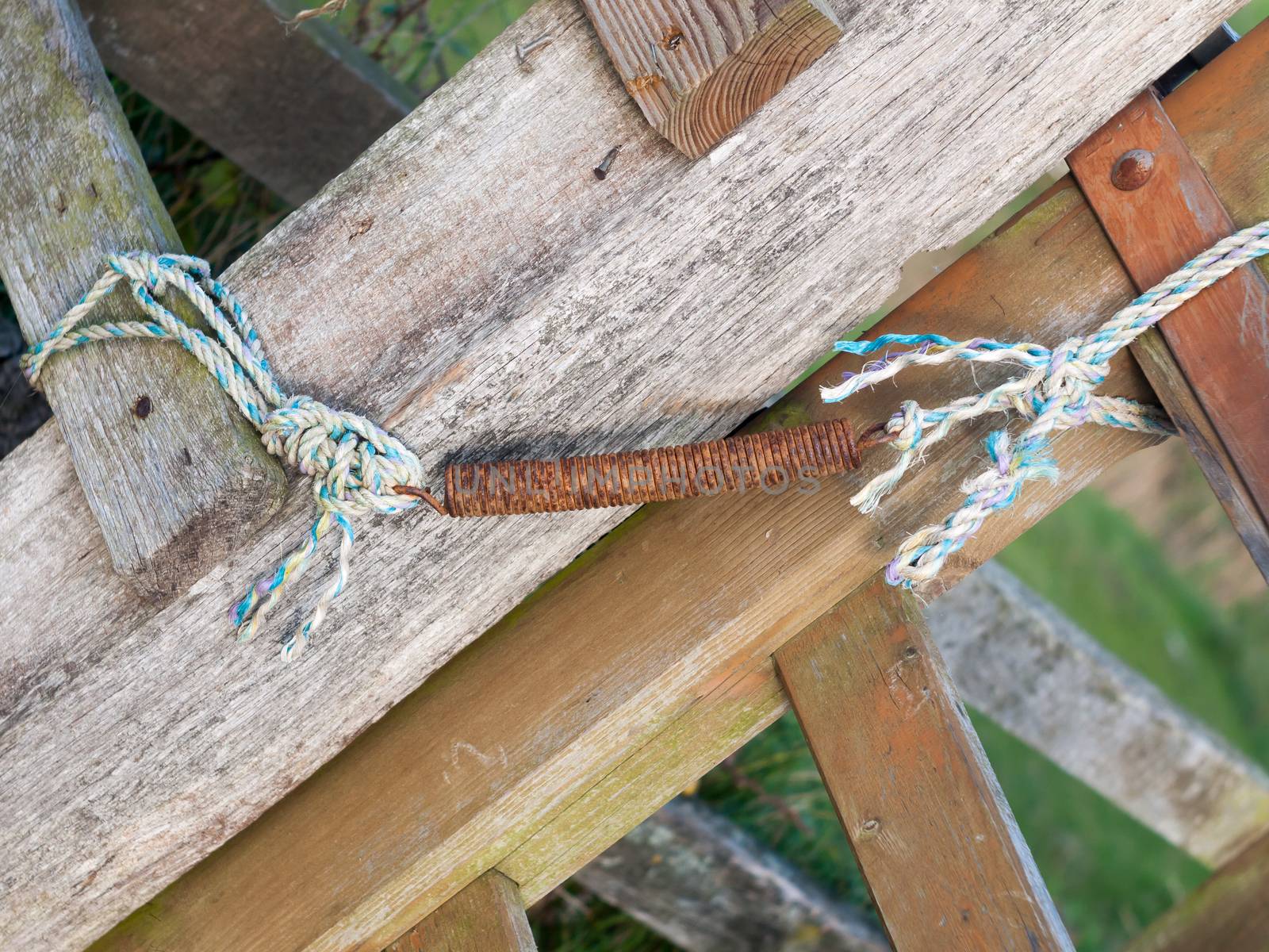 rusted spring metal element on countryside gate detail sharp; England; Essex