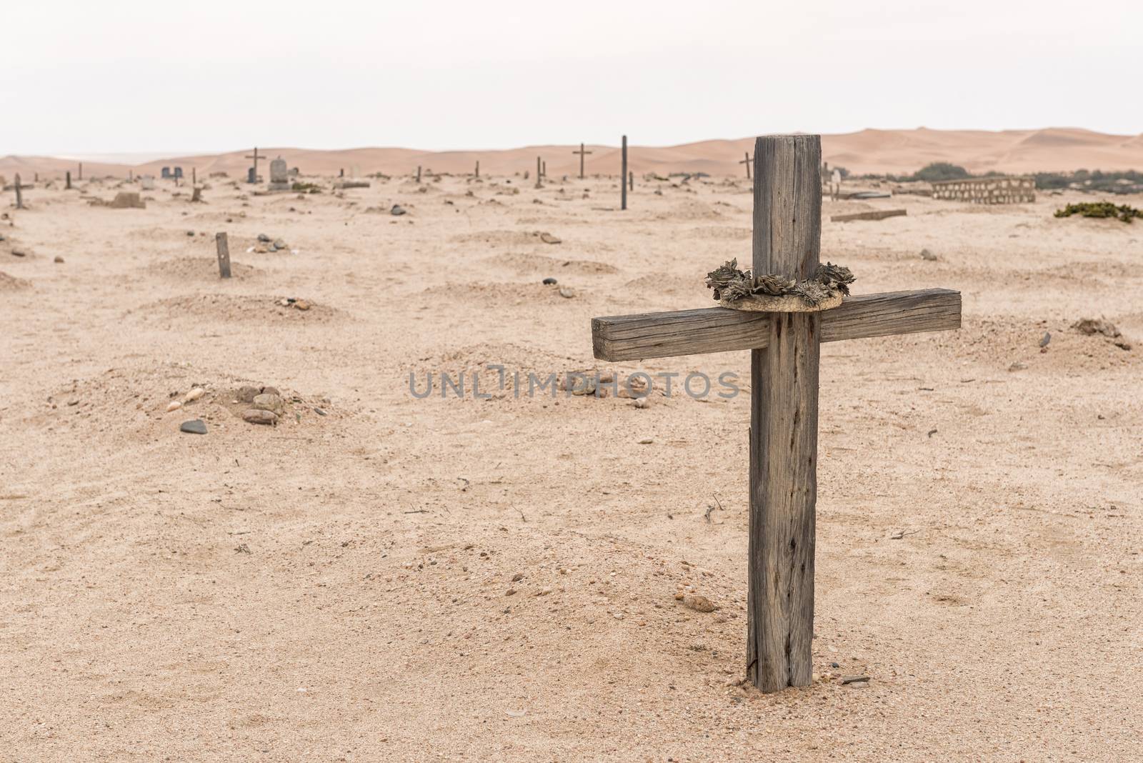 A grave in the historic Herero cemetery in Swakopmund in the Namib Desert on the Atlantic Coast of Namibia. Sand dunes are in the back