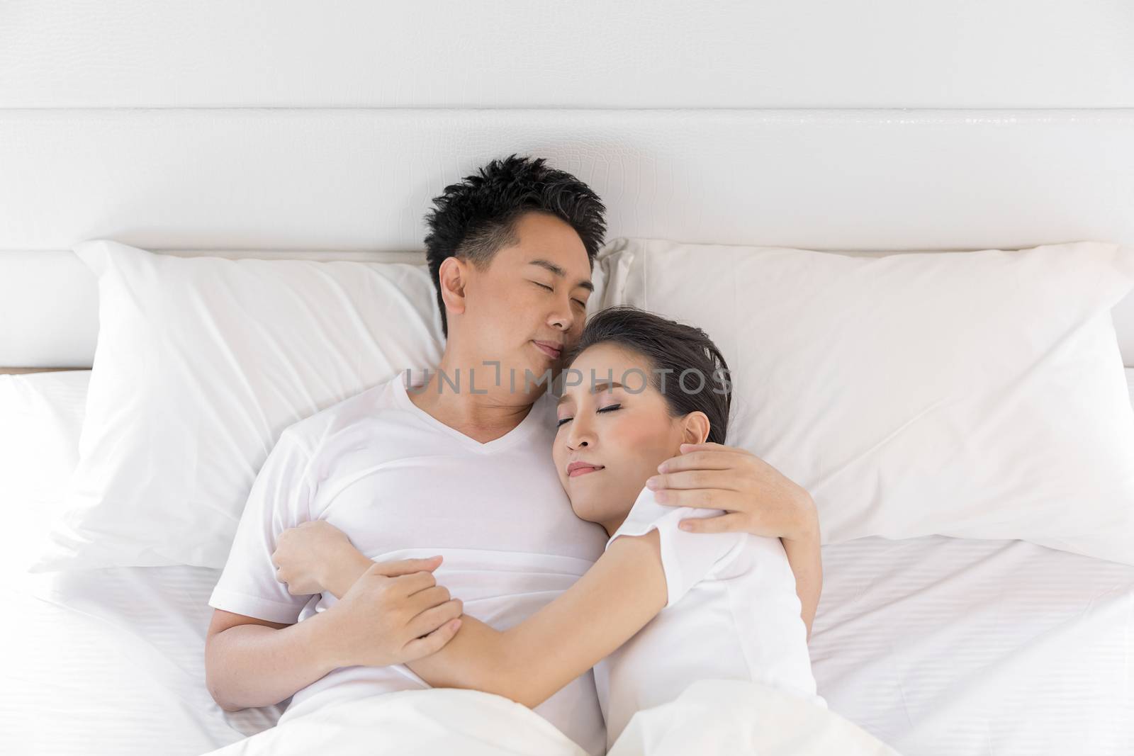 Young loving couple in the bed. Modern lifestyle concept