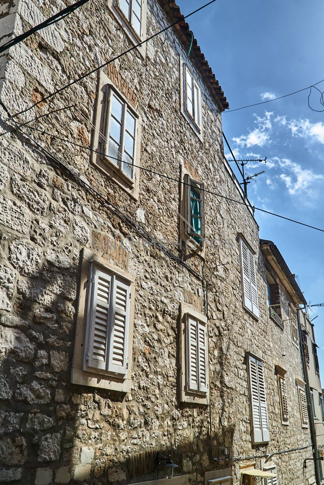 Street with stone tenement houses in Sibenik, Croatia