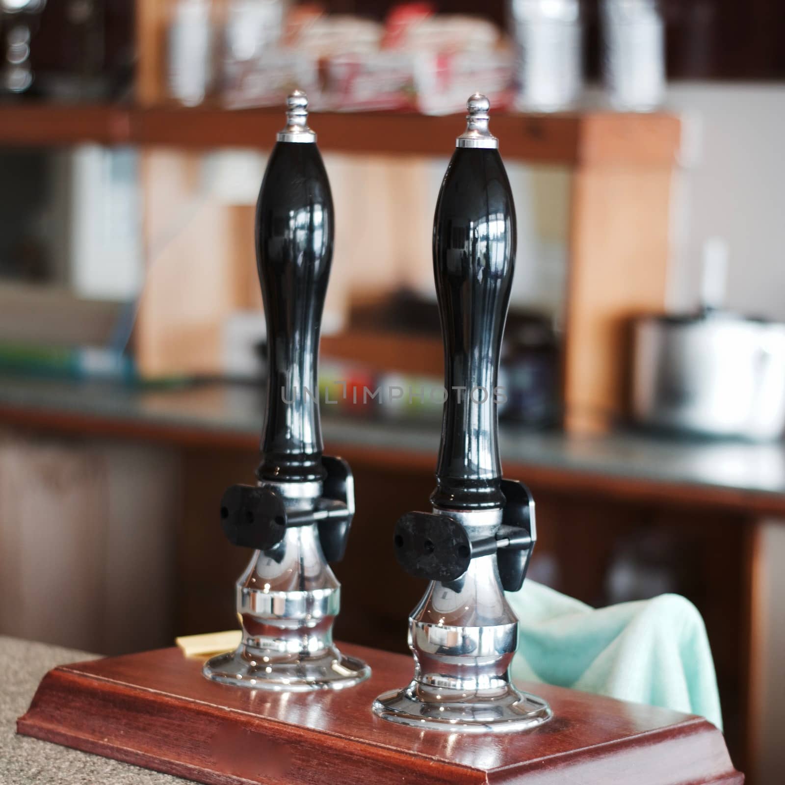 Two long bar beer tap on the wooden table. Restaurant drink concept.