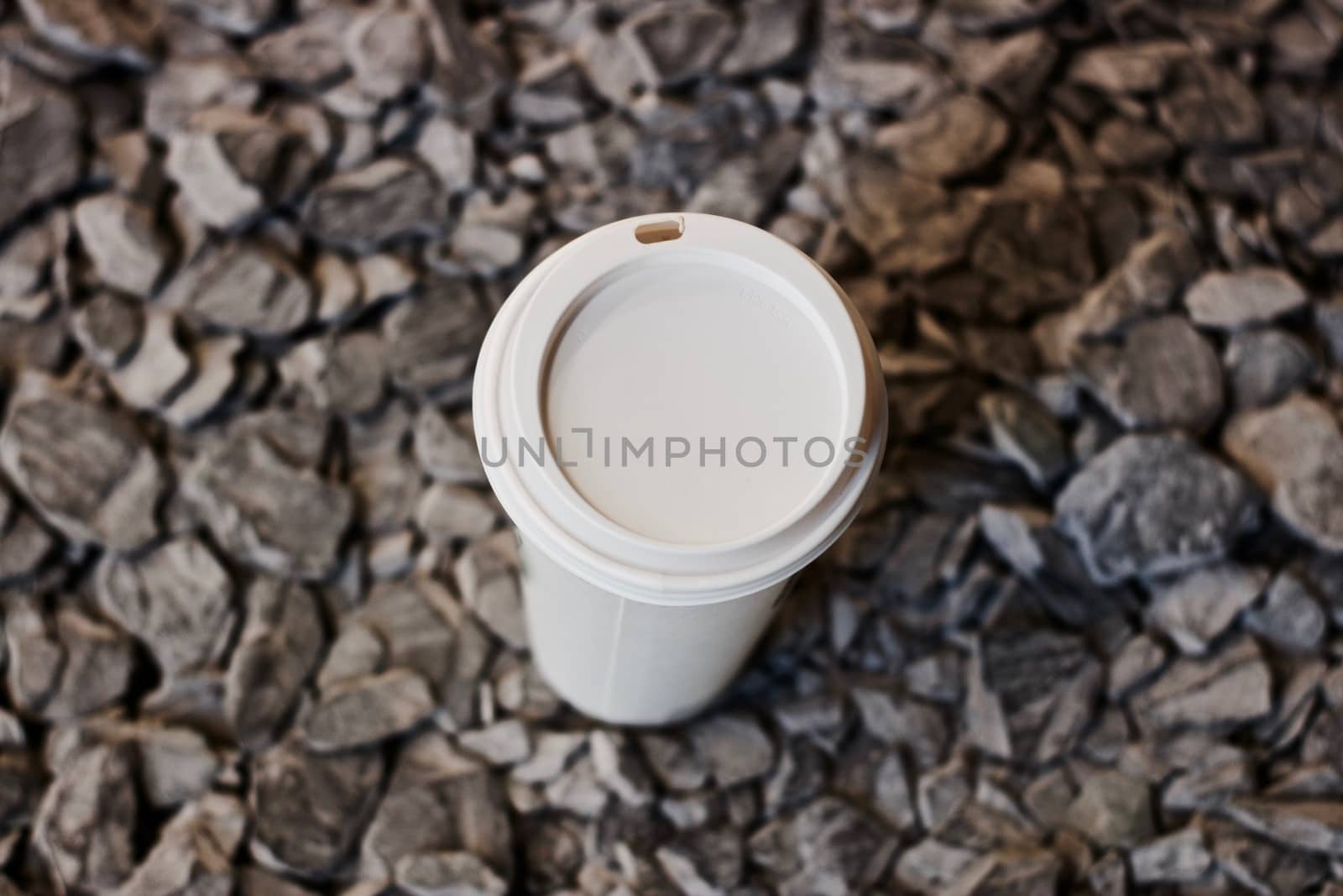Big white coffee cup on the grey stones. Coffee lovers concept.