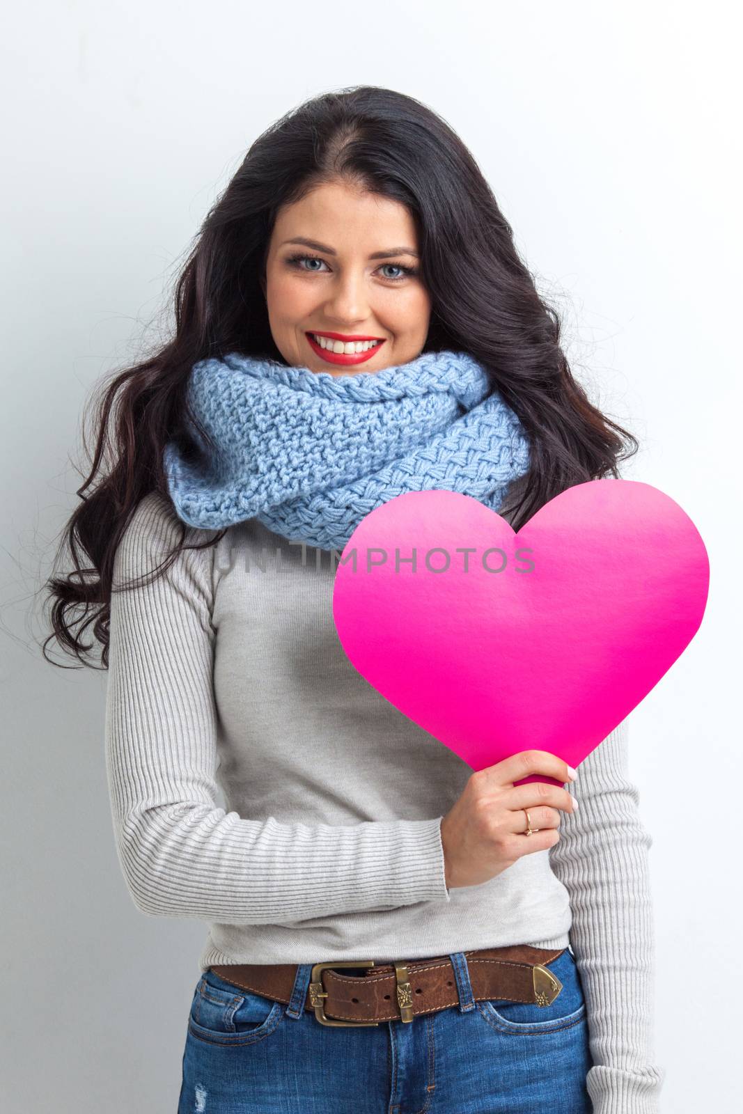 Woman holding pink paper heart by Yellowj