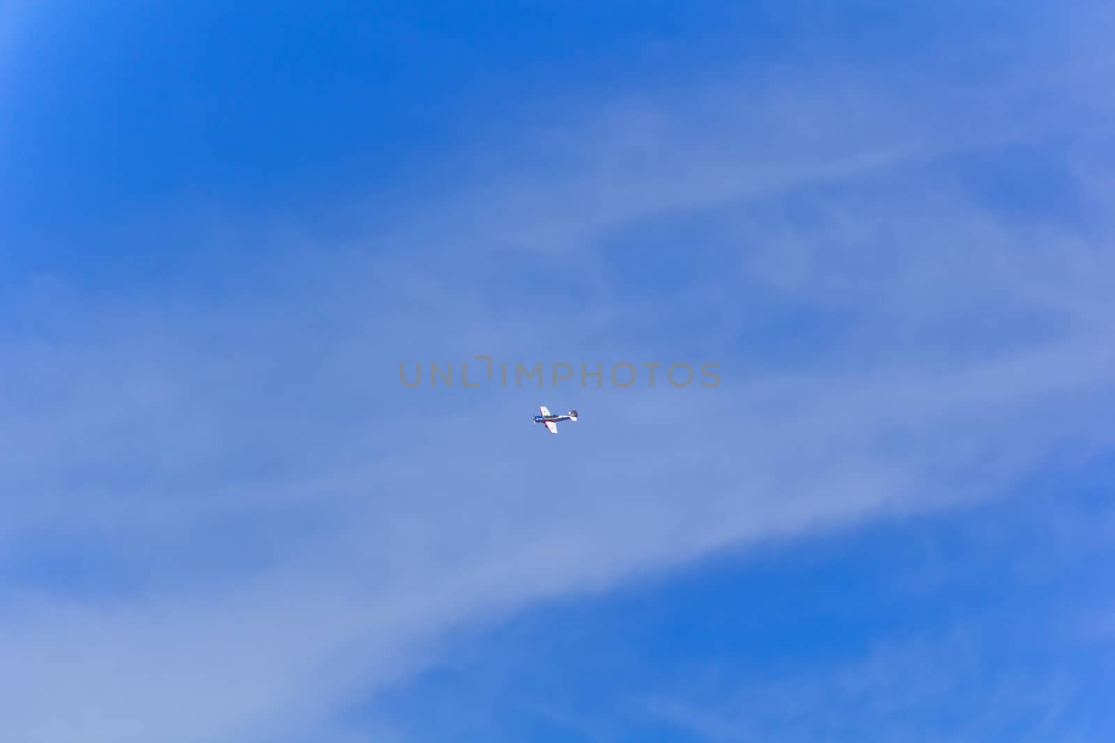 Photo of flying military airplane in blue sky