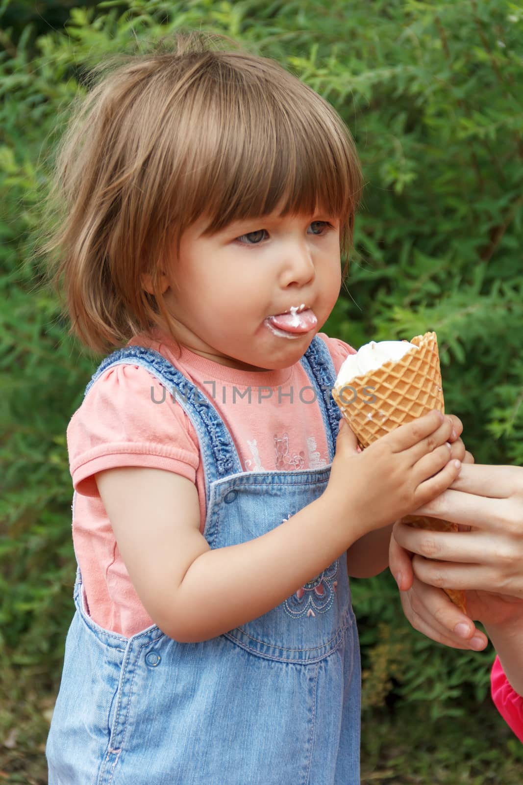 Baby are eating icecream with put out tongue by Julialine