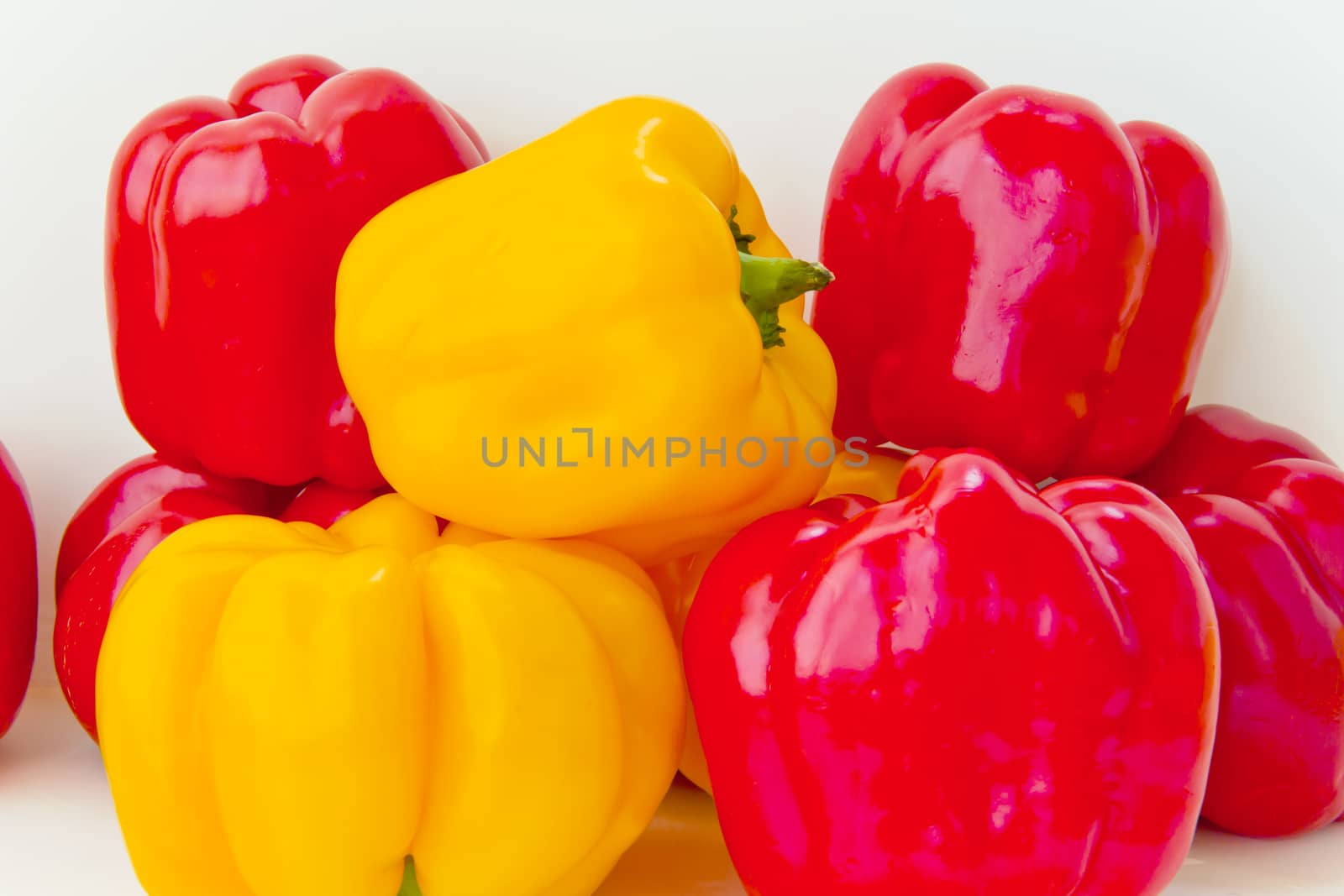 Red and yellow raw pepper by Julialine