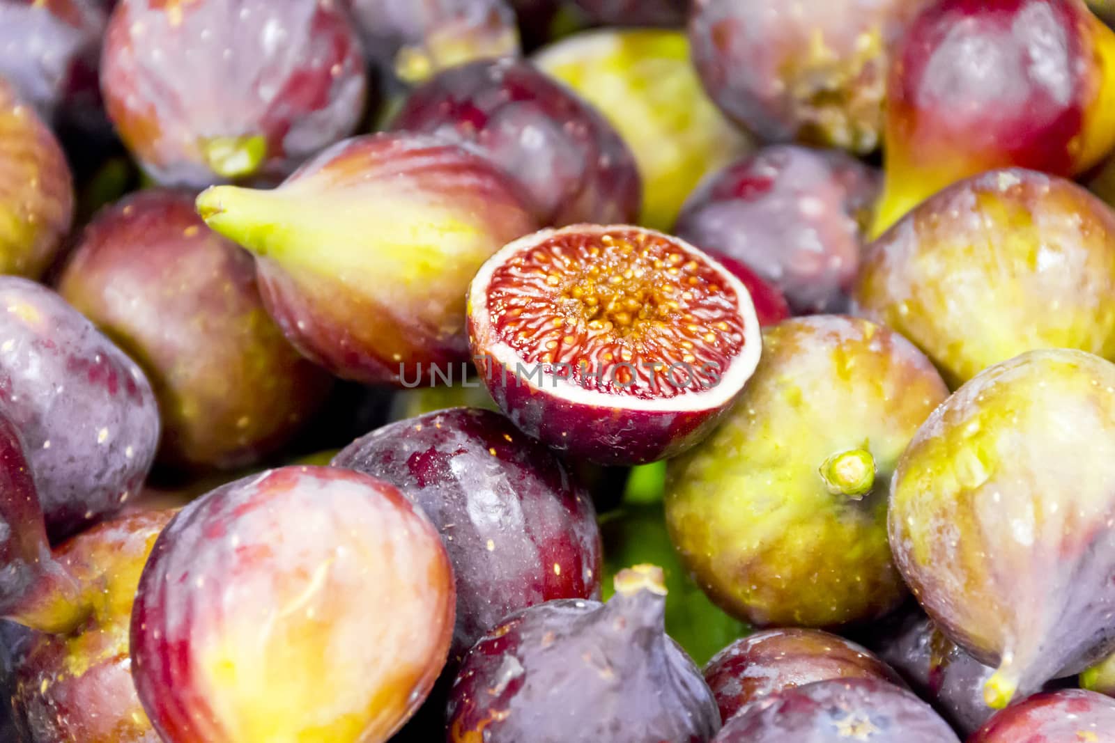 Background of appetizing figs on counter in market place