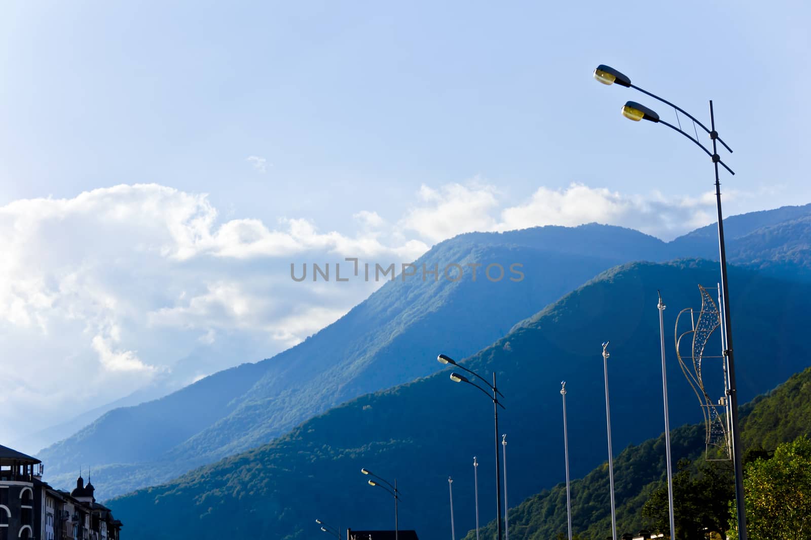 Blue Russian Caucasus mountains landscape with pole wires lights