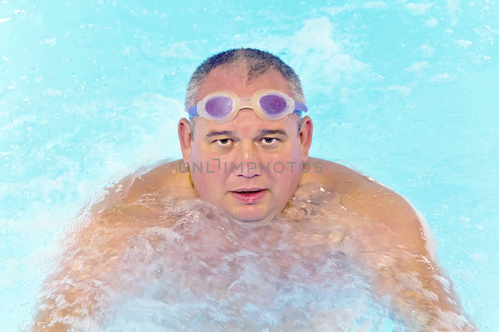 Portrait of big fat man in swimming pool water