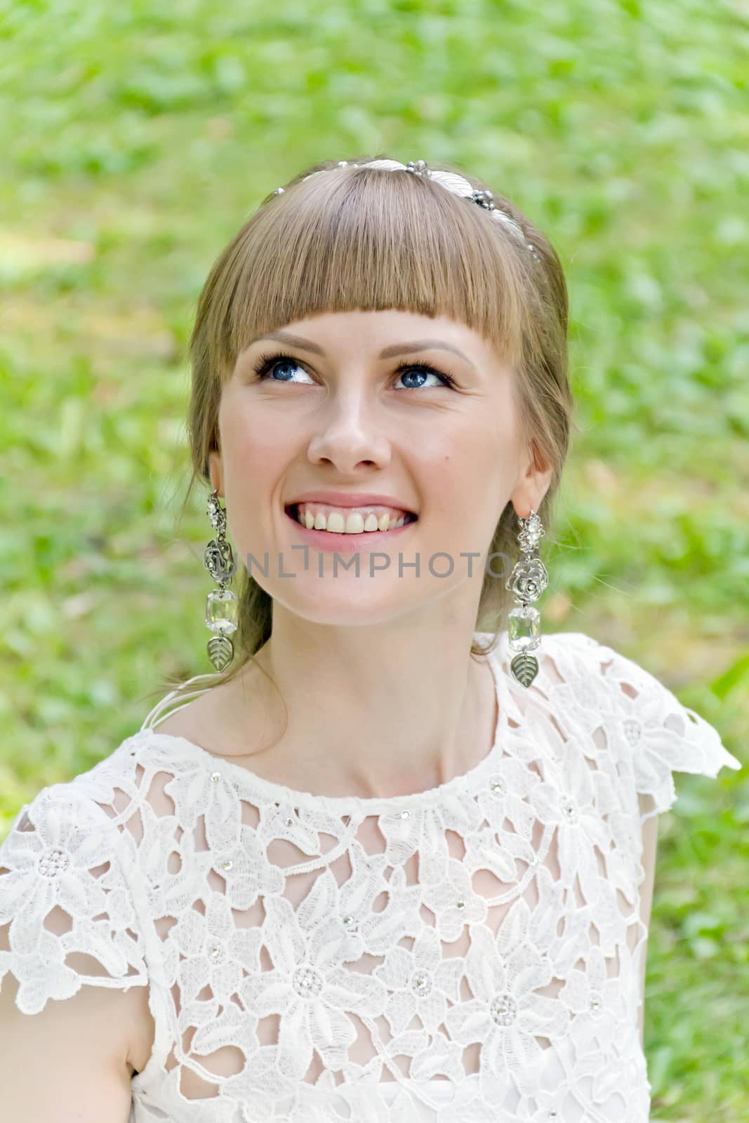 Portrait of beautiful girl with blue eyes looking upwards